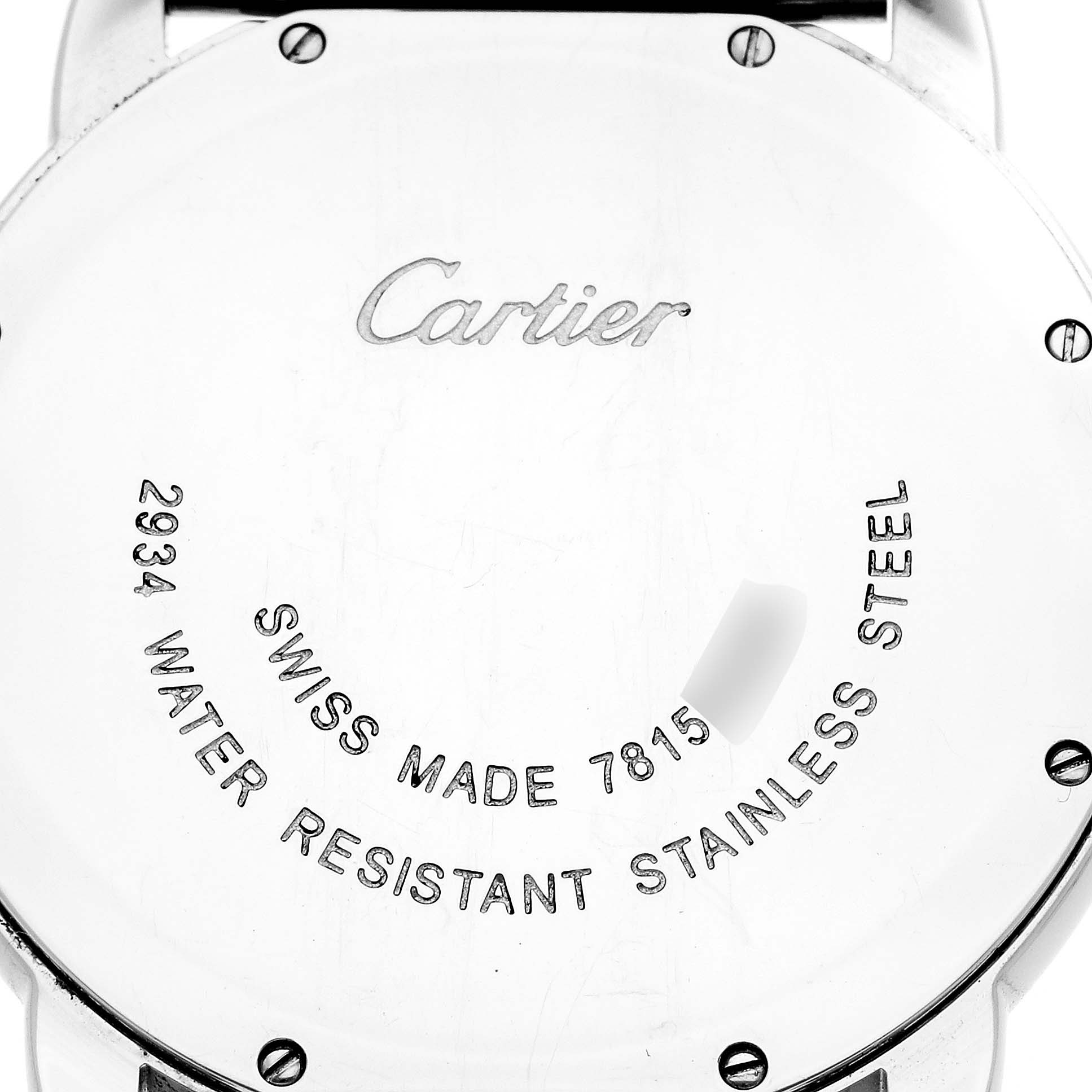 This image shows the back case of a Ronde model by Cartier, highlighting the engravings and screws.