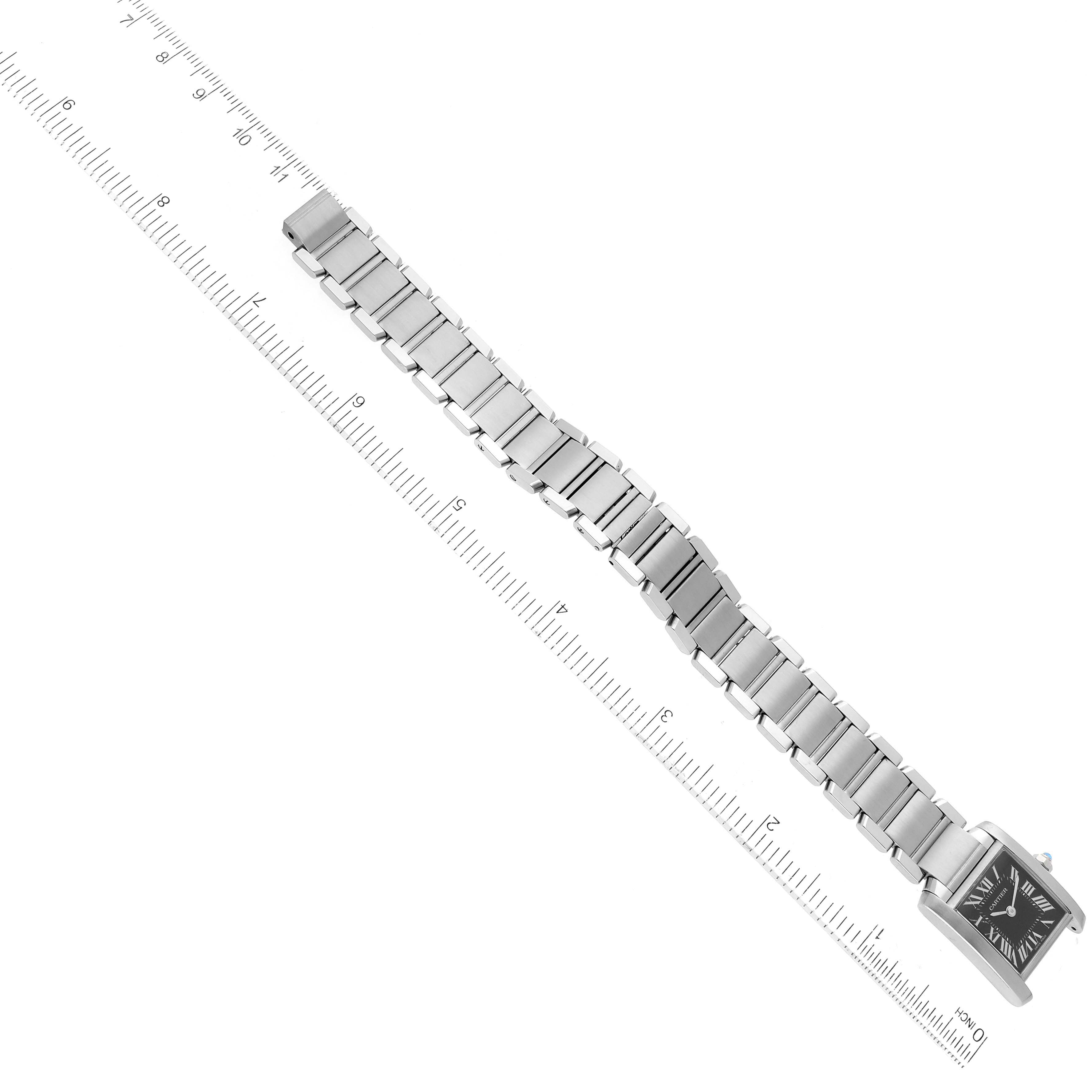 The image shows a Cartier Tank Francaise W51026Q3 Women's Stainless Steel Black Dial W51026Q3 Women's Stainless Steel Black Dial watch laid flat with its metal bracelet fully extended alongside a ruler for scale.