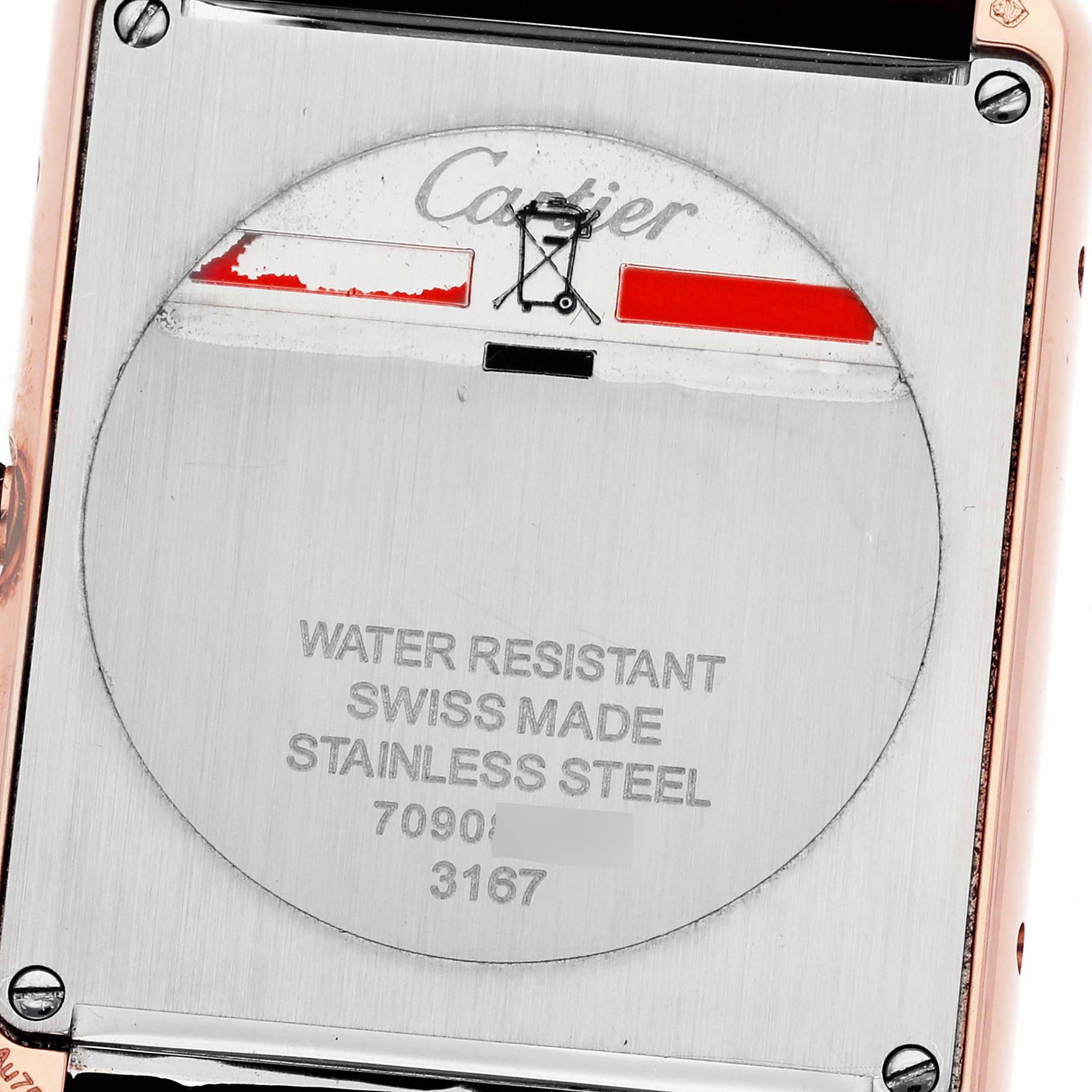 This is a close-up of the back of a Tank Solo model by Cartier, showing its stainless steel case and inscriptions.