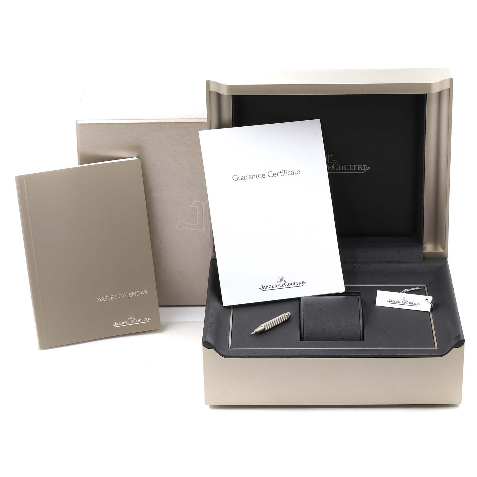The image shows the Jaeger-LeCoultre Master model box, instruction manual, guarantee certificate, and watch accessories.