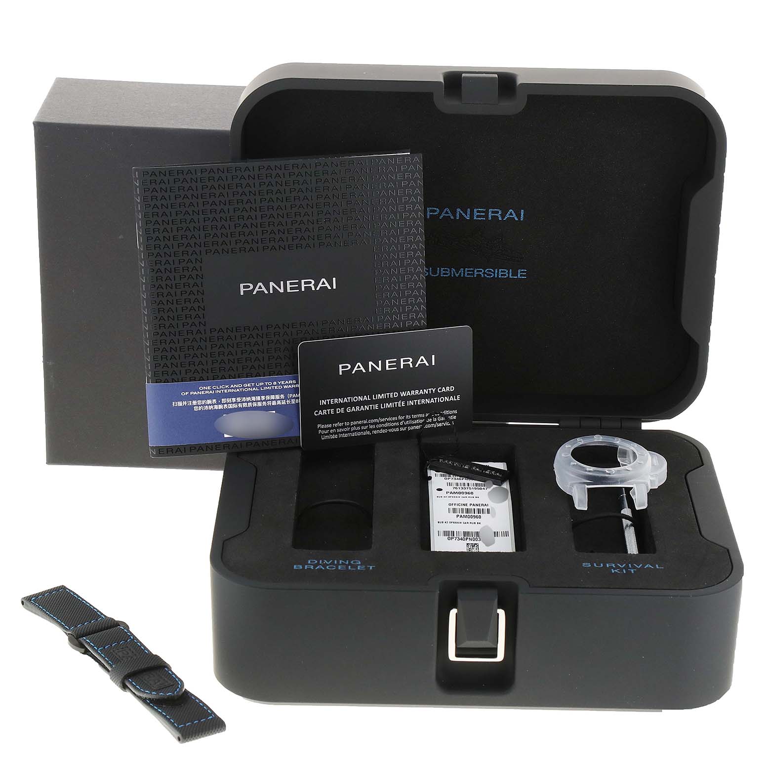 The image shows a Panerai Submersible PAM00960 Men's Ceramic Black Dial PAM00960 Men's Ceramic Black Dial watch box from a top-down angle, featuring documentation, extra strap, and various accessories.
