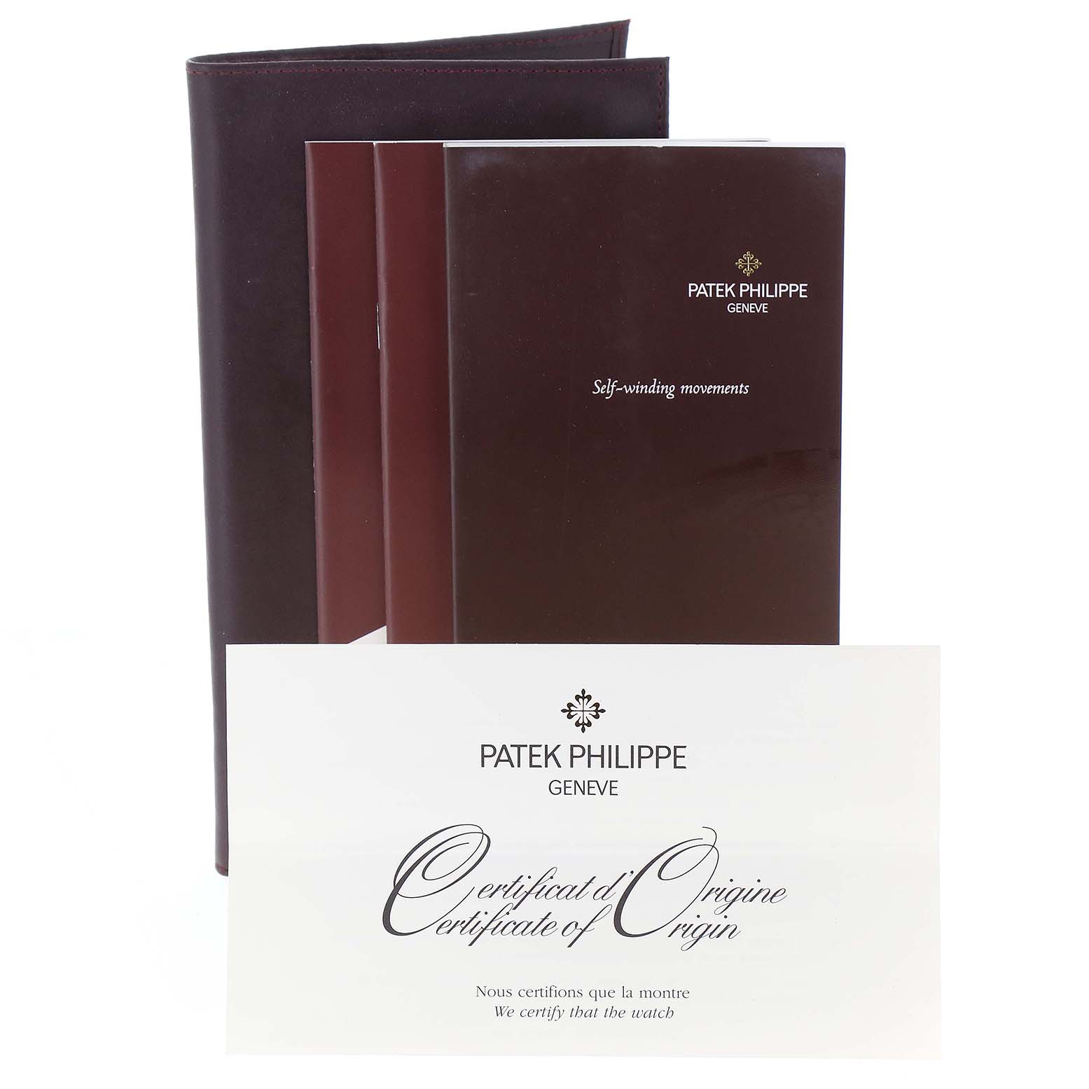 The image shows documentation and a leather folio for a Patek Philippe Calatrava 3802 Men's Rose Gold Beige Dial 3802 Men's Rose Gold Beige Dial watch, including a certificate of origin.