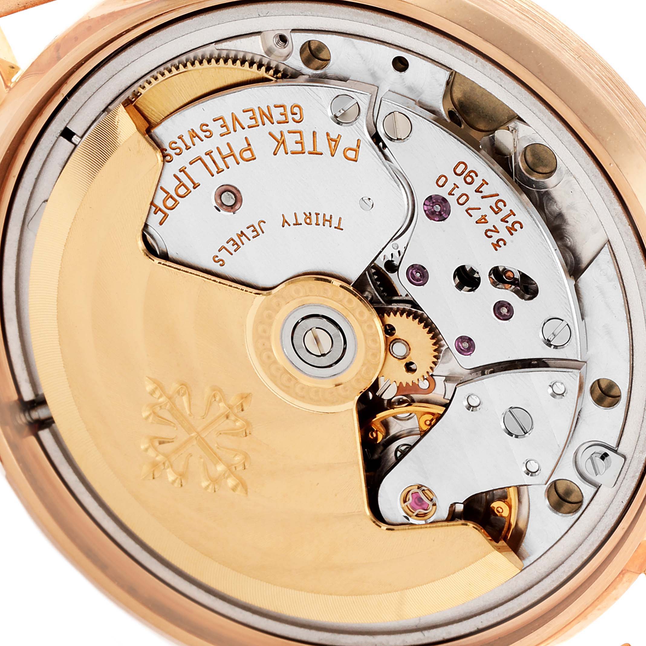The image shows the movement and inner mechanics of a Patek Philippe Calatrava 3802 Men's Rose Gold Beige Dial 3802 Men's Rose Gold Beige Dial watch at a close-up, detailed angle.