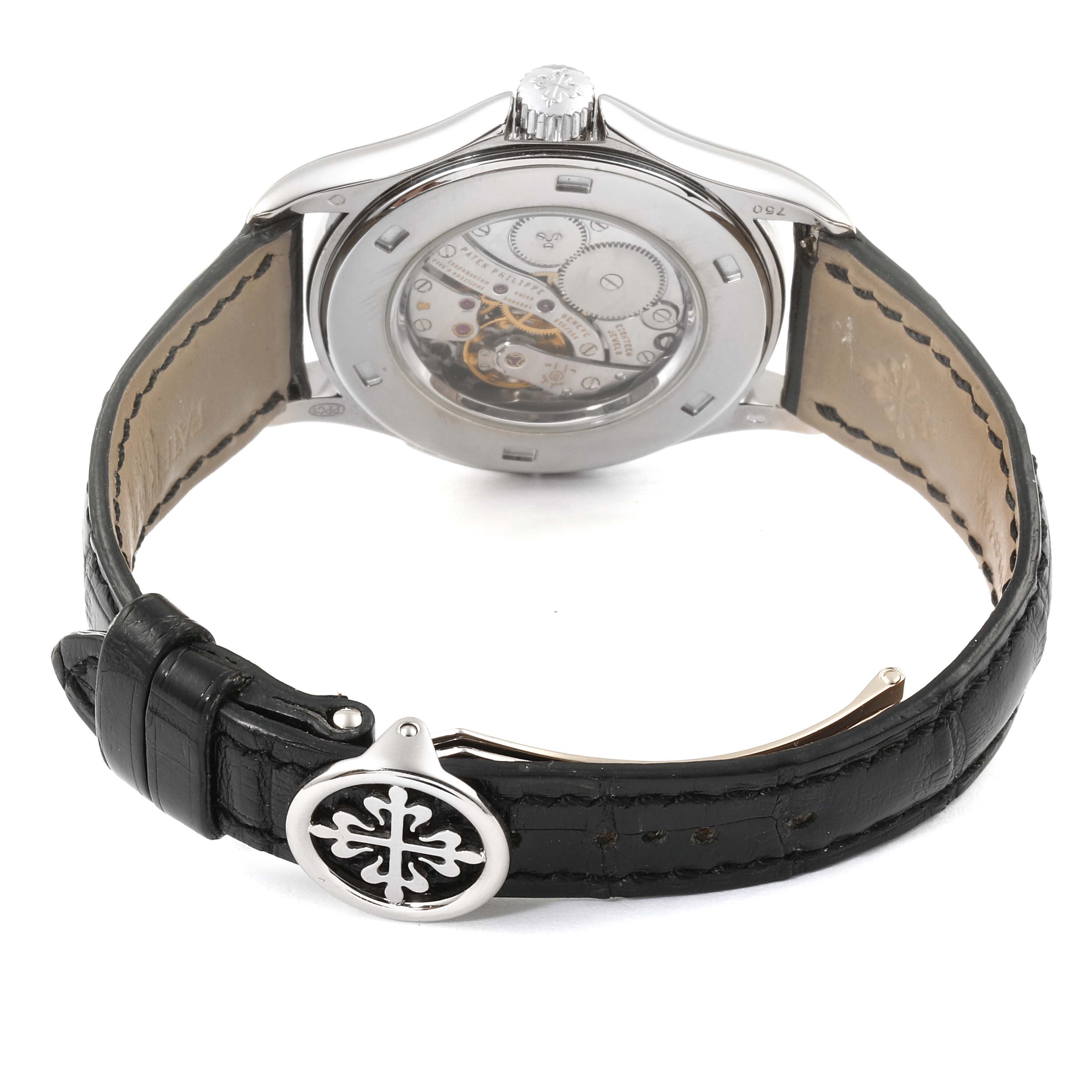 The image shows the back view of the Calatrava model by Patek Philippe, highlighting its movement and black leather strap.
