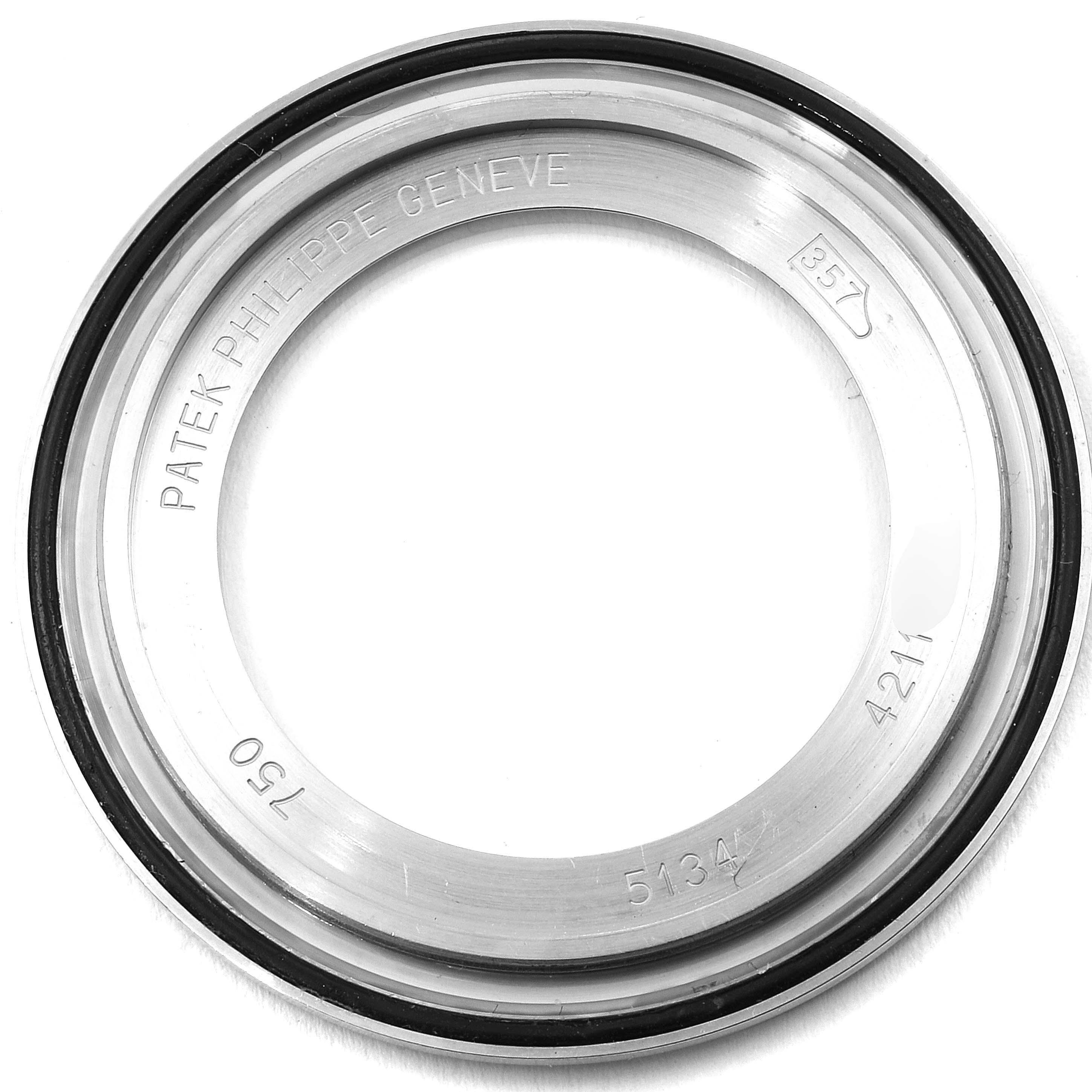 The image shows a bezel of a Calatrava model by Patek Philippe from a top-down angle.