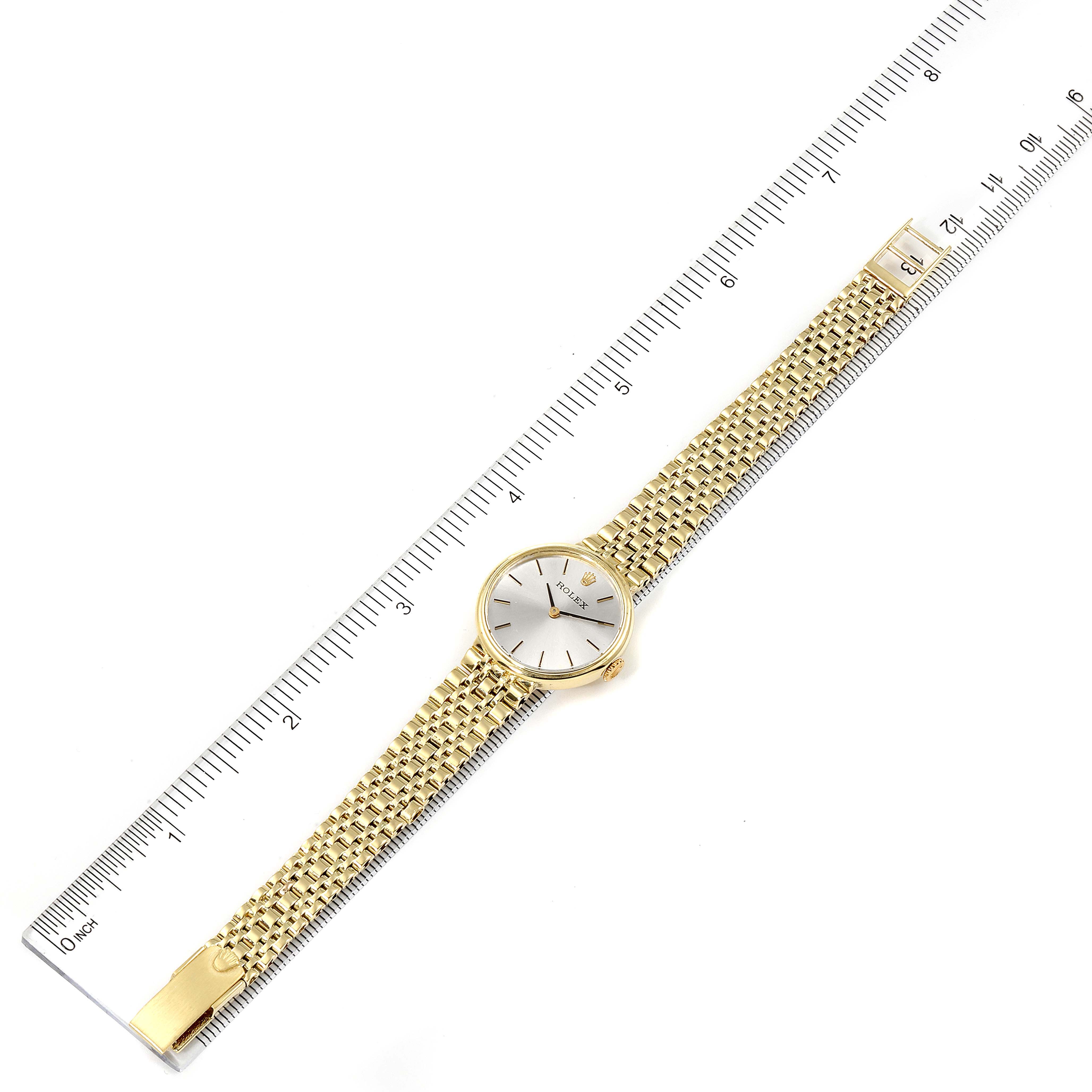 The image shows a top-view angle of a Rolex Cocktail  Women's Yellow Gold Silver Dial  Women's Yellow Gold Silver Dial model watch, including the dial, bracelet, and clasp.