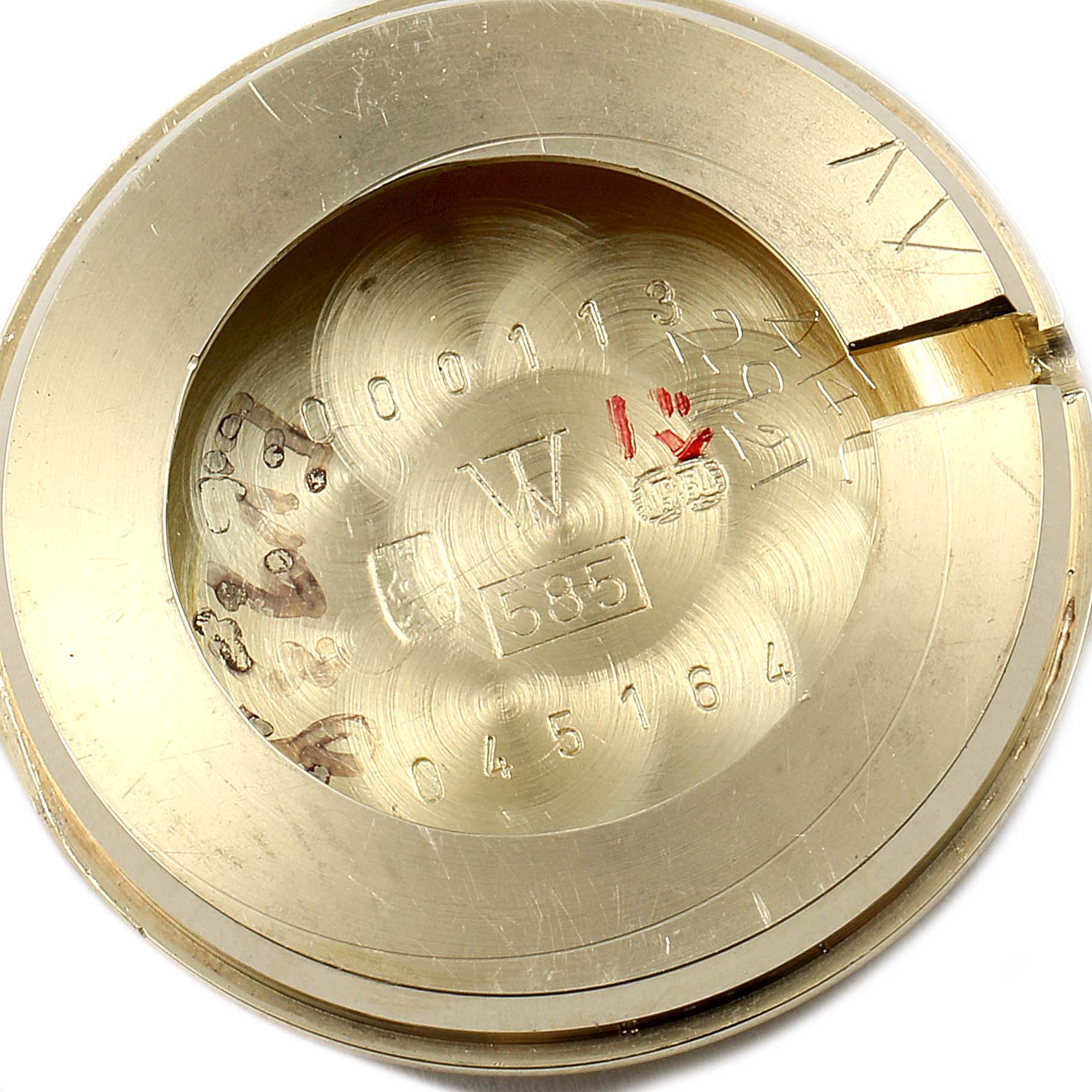 The image shows the inside of the case back for a Rolex Cocktail  Women's Yellow Gold Silver Dial  Women's Yellow Gold Silver Dial model watch, highlighting its engravings and hallmark.
