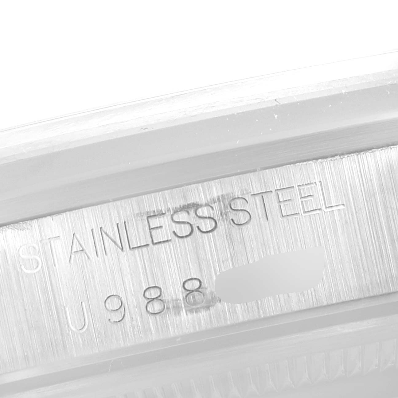This image shows a close-up of the stainless steel engraving and serial number of a Rolex Air-King 14000 Men's Stainless Steel Black Dial 14000 Men's Stainless Steel Black Dial watch.