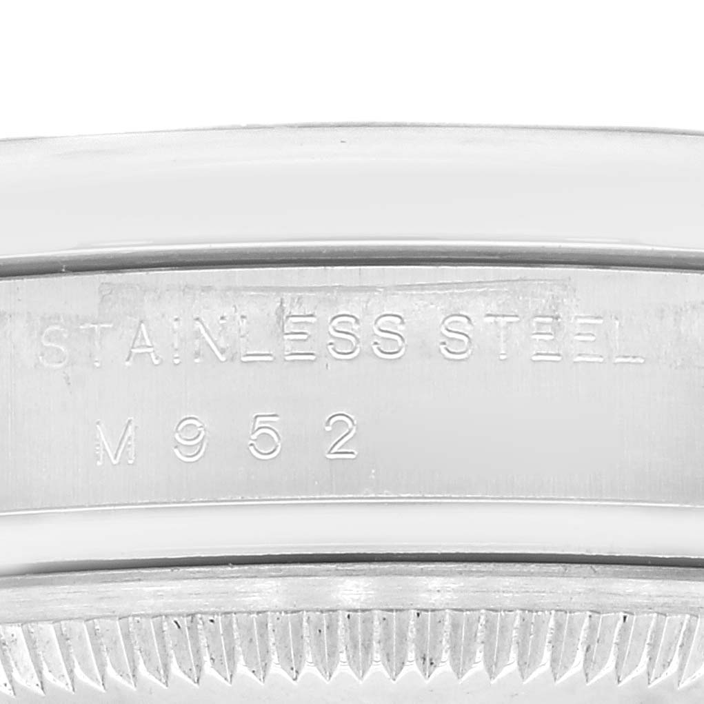 This image shows a close-up of the stainless steel casing and serial engraving on a Rolex Air-King 114200 Men's Stainless Steel Pink Dial 114200 Men's Stainless Steel Pink Dial watch.