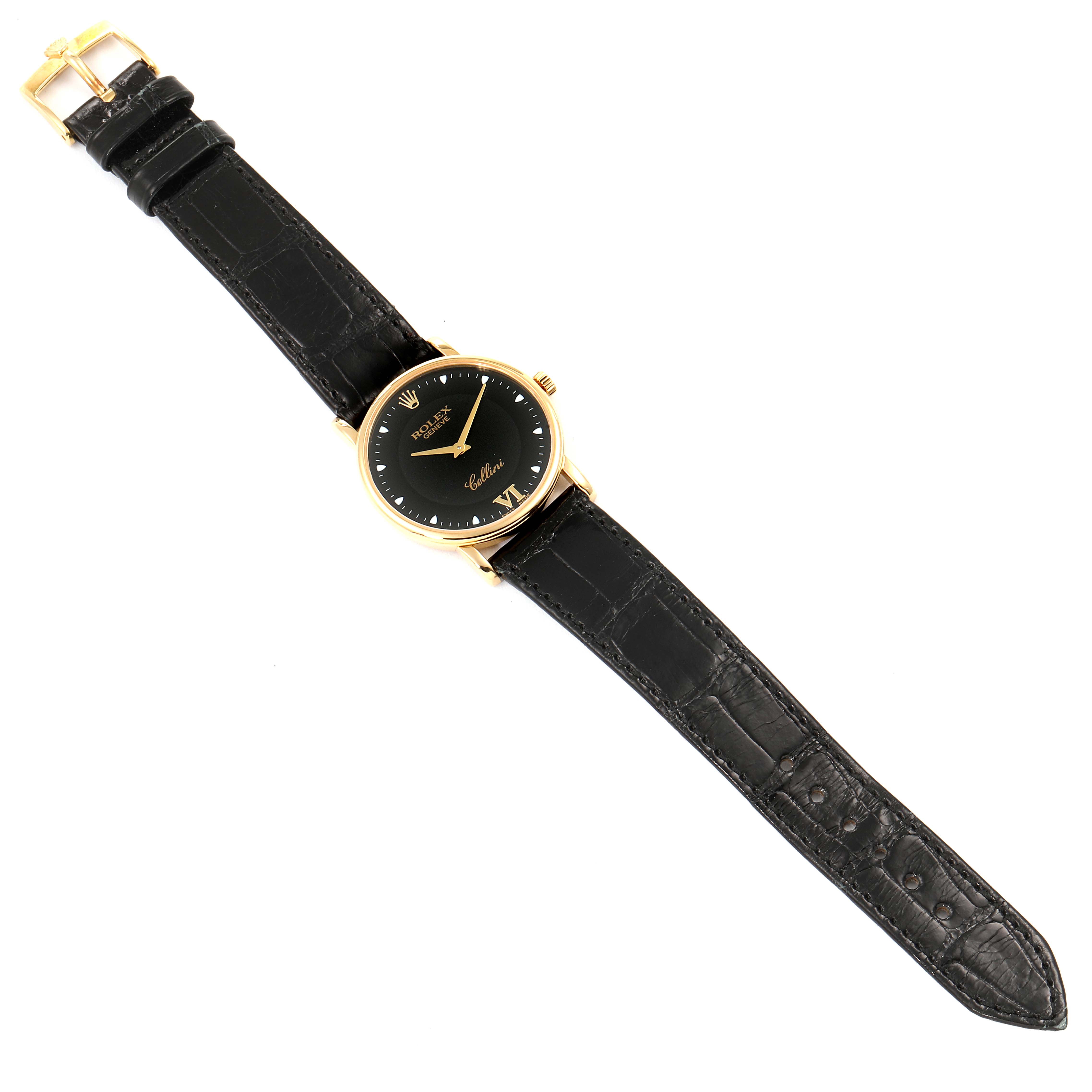 The Rolex Cellini 5115 Men's Yellow Gold Black Dial 5115 Men's Yellow Gold Black Dial watch is shown from a top-down angle, displaying the entire watch including the face and the strap with a buckle.