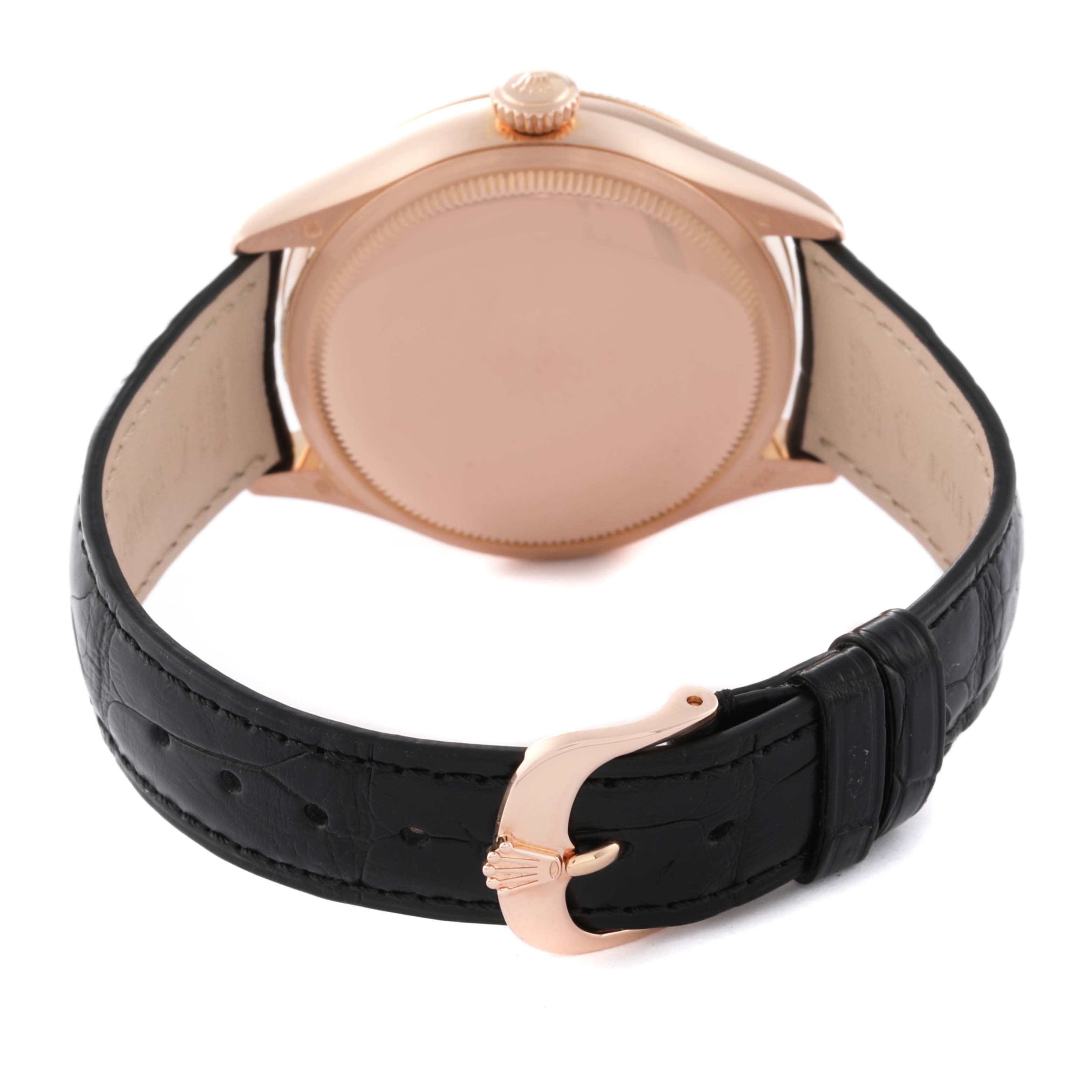 This image shows the backside of a Rolex Cellini 50515 Men's Rose Gold Silver Dial 50515 Men's Rose Gold Silver Dial watch, highlighting its case back, crown, and black leather strap with a gold clasp.