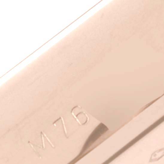 The image shows a close-up angle of a section of the Rolex Cellini 5442/5 Men's Rose Gold Black Dial 5442/5 Men's Rose Gold Black Dial watch, featuring part of the serial number "M76."