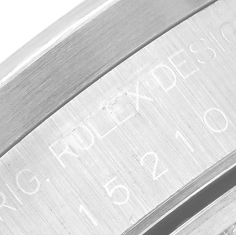 This close-up angle of the Rolex Date 15210 Men
s Stainless Steel Grey Dial 15210 Men
s Stainless Steel Grey Dial model showcases part of the watch case with engraved text.