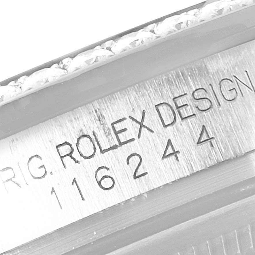This image shows the serial number and "ROLEX DESIGN" engraving on the case of a Rolex Datejust 116244 Men's Stainless Steel Brown Dial 116244 Men's Stainless Steel Brown Dial watch.