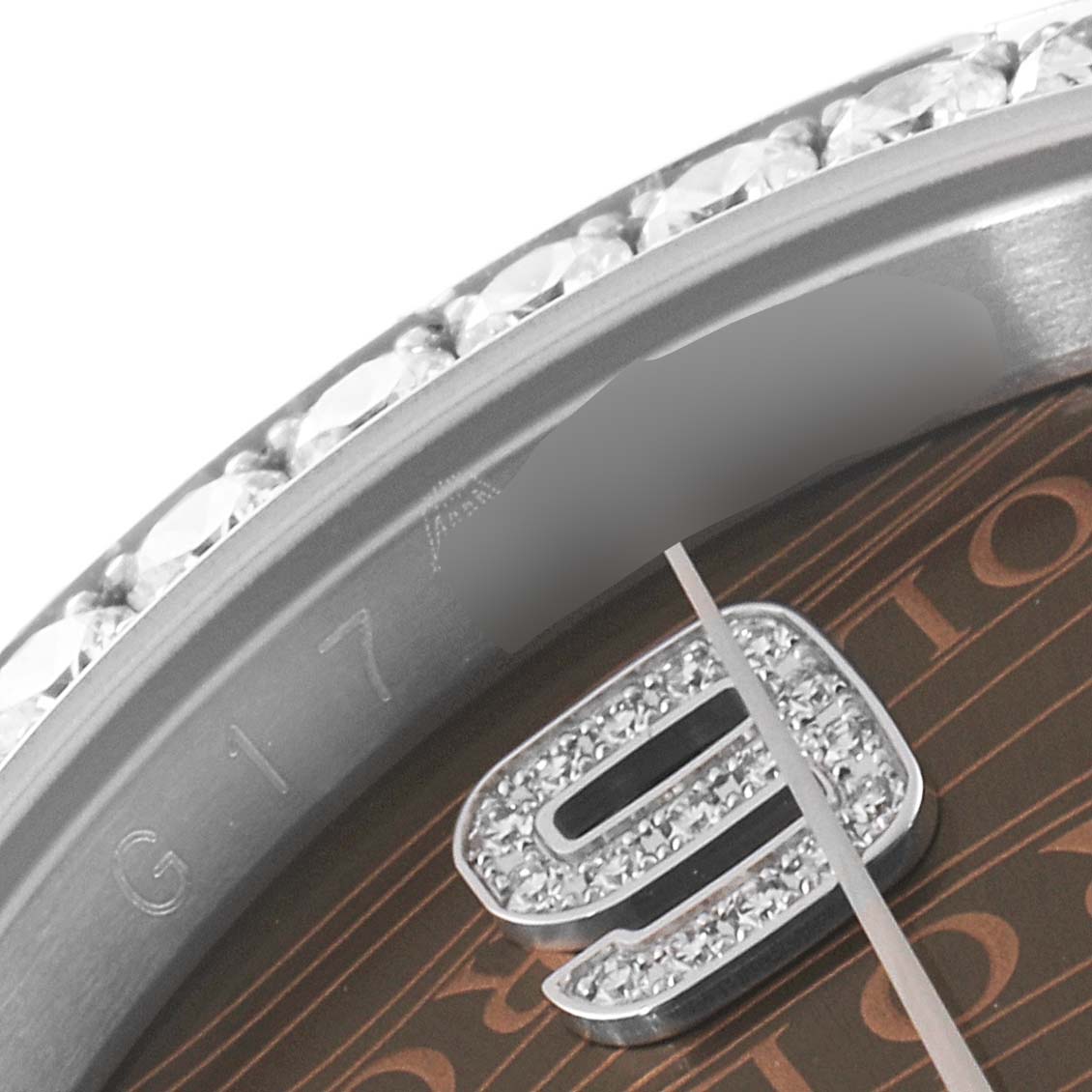 This close-up image shows the bezel, part of the dial, and the number 9 marker of the Rolex Datejust 116244 Men's Stainless Steel Brown Dial 116244 Men's Stainless Steel Brown Dial model.