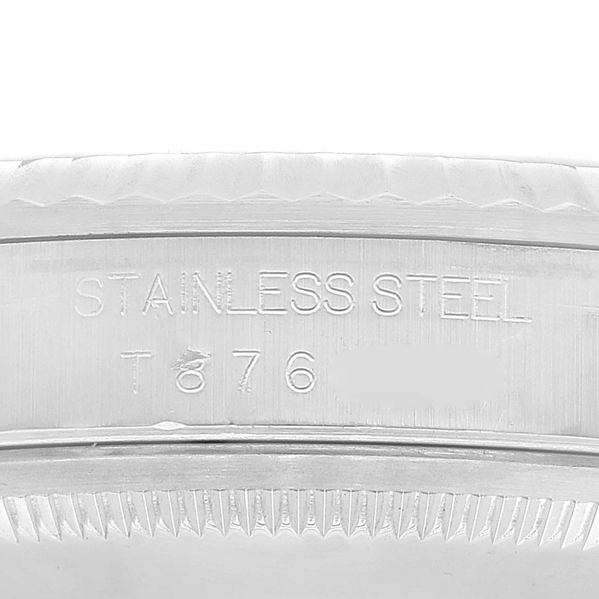 Close-up of the inner bezel of a Rolex Datejust 16234 Men's Stainless Steel Blue Dial 16234 Men's Stainless Steel Blue Dial, showing the "STAINLESS STEEL" engraving and partial serial number.