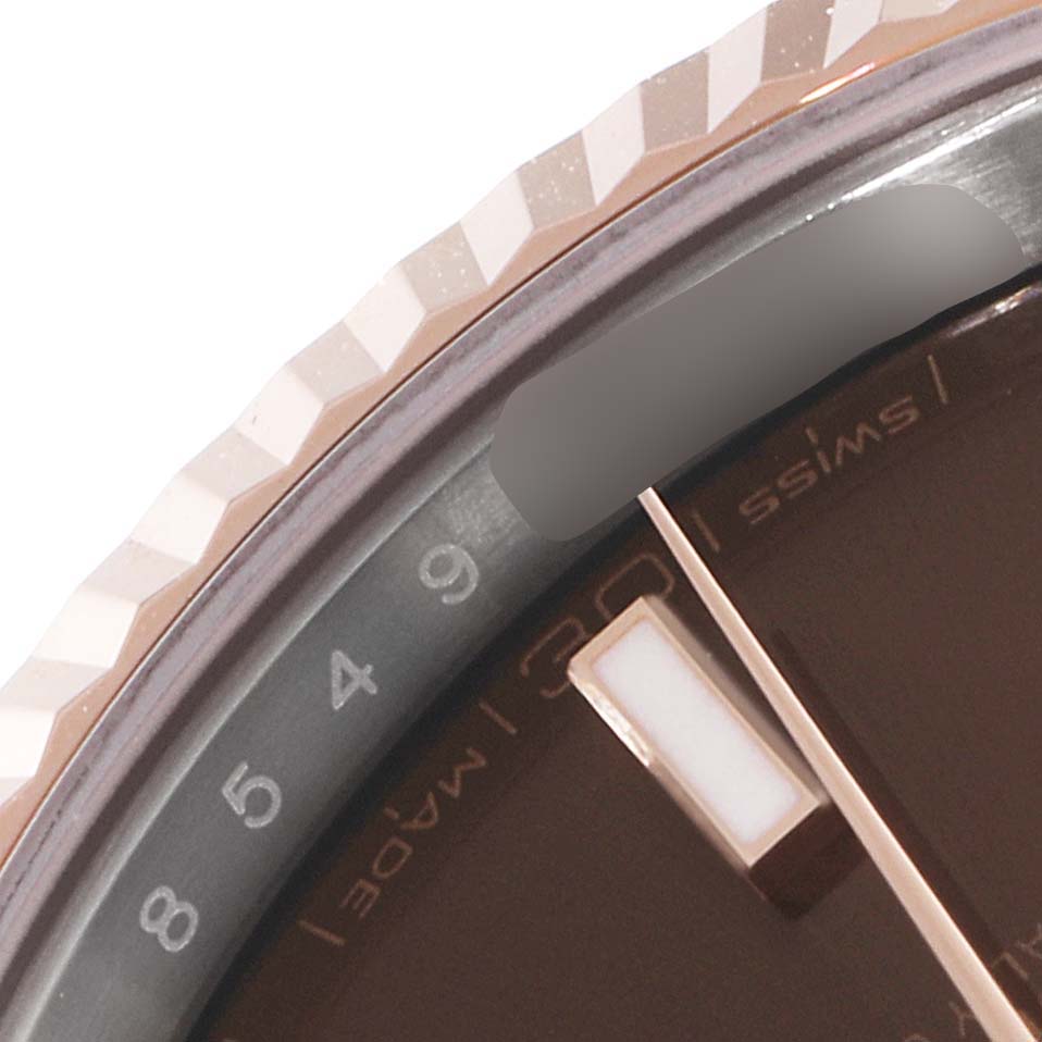 This close-up angle of the Rolex Datejust 41 126331 Men's Steel and Gold (two tone) Brown Dial 126331 Men's Steel and Gold (two tone) Brown Dial shows the bezel, part of the dial, and a segment of the minute hand.