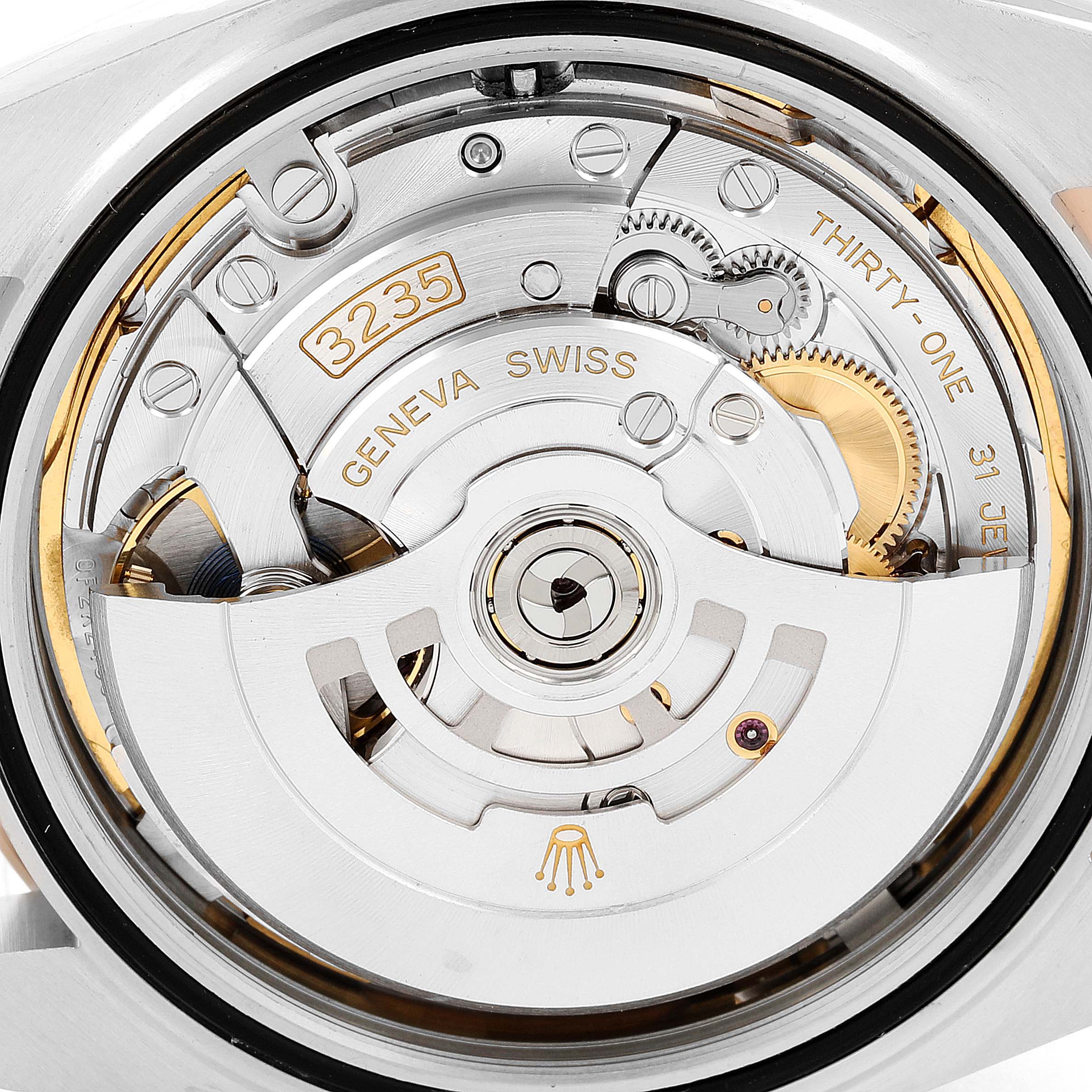 This image shows a close-up of the Rolex Datejust 41 126331 Men's Steel and Gold (two tone) Brown Dial 126331 Men's Steel and Gold (two tone) Brown Dial movement, specifically the caliber 3235 with intricate gears and parts visible.