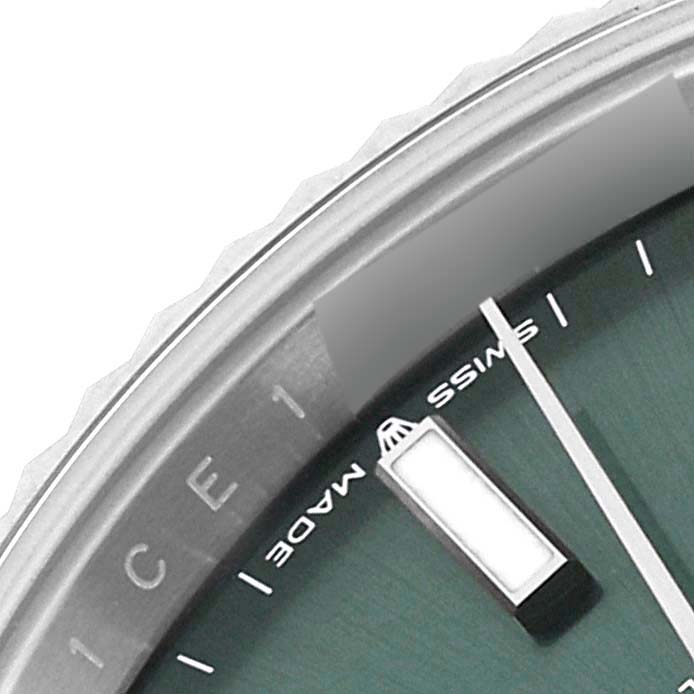 This close-up image of the Rolex Datejust 41 126334 Men's Stainless Steel Green Dial 126334 Men's Stainless Steel Green Dial watch shows a portion of the dial, minute marker, and the bezel.