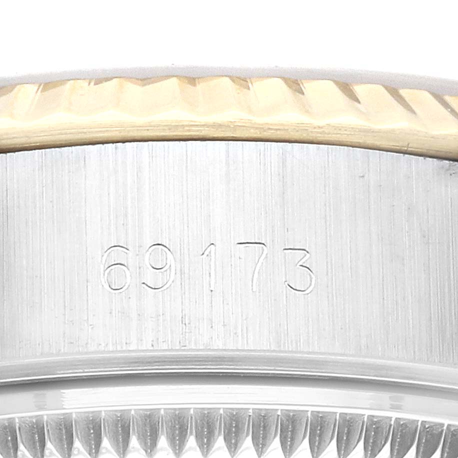 The image shows a close-up of the Rolex Datejust 69173 Women's Steel and Gold (two tone) Champagne Dial 69173 Women's Steel and Gold (two tone) Champagne Dial model 69173, focusing on the serial number and part of the bezel.