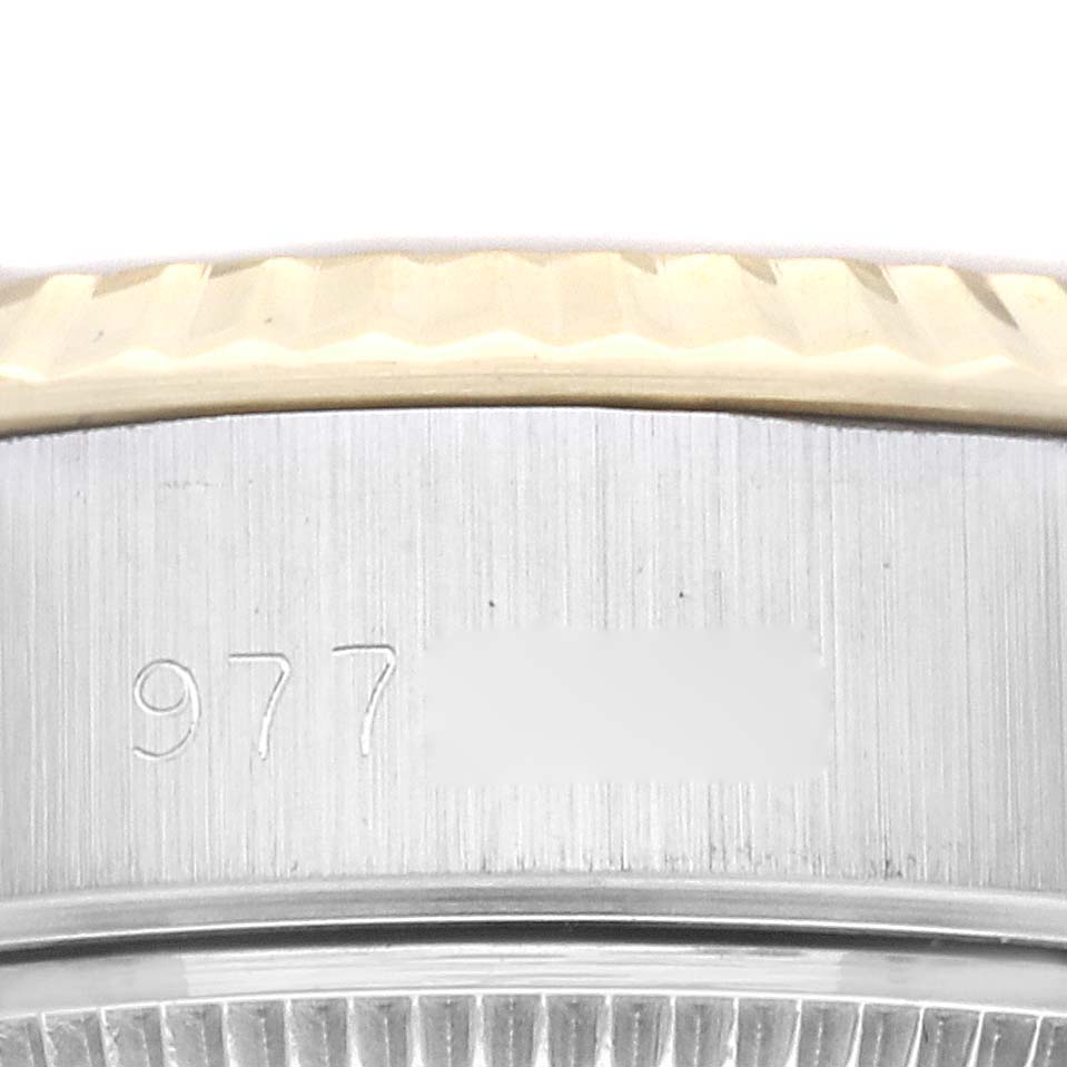 The image shows a close-up of the side of a Rolex Datejust 69173 Women's Steel and Gold (two tone) Champagne Dial 69173 Women's Steel and Gold (two tone) Champagne Dial watch, focusing on the bezel and the engraved number.