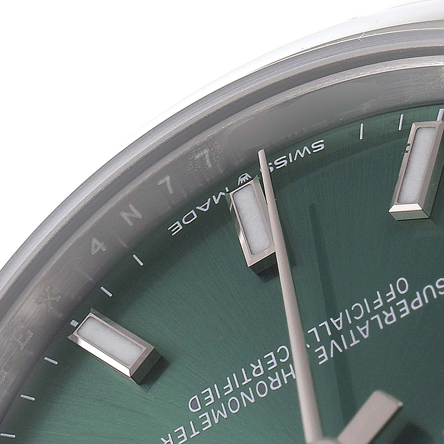 This image shows a close-up of the dial's upper segment of a Mid-Size Rolex watch, highlighting the hands, markers, and the "Swiss Made" text.