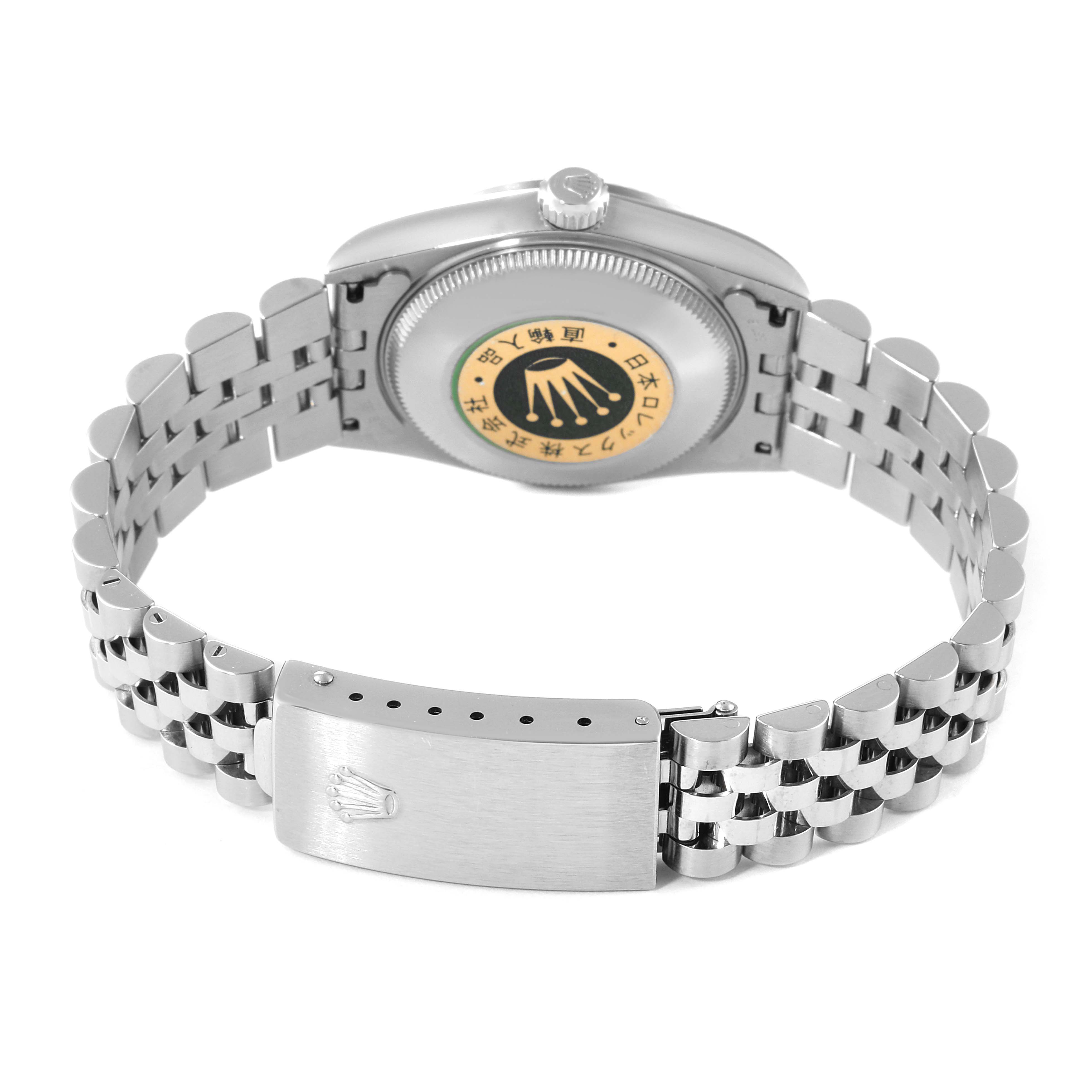 The image shows the back view of a Mid-Size Rolex watch highlighting the caseback and the bracelet with the clasp.