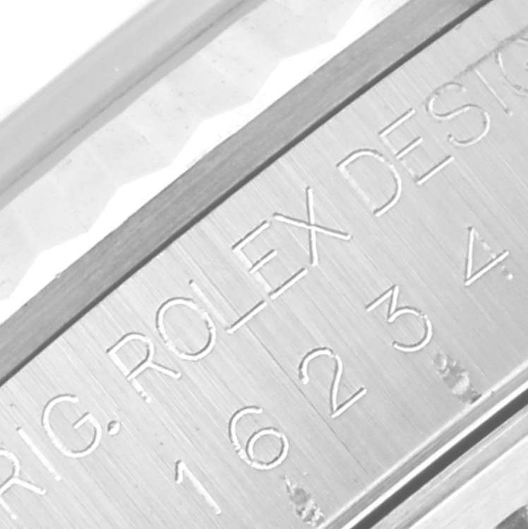 This close-up image shows the engraved model number and "Rolex" brand on the side of a Rolex Datejust 16234G Men's Stainless Steel Black Dial 16234G Men's Stainless Steel Black Dial watch case.