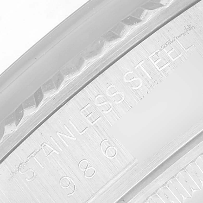 This close-up image shows the engraved inner rim of a Rolex Vintage Collection 16014 Men's Stainless Steel Silver Dial 16014 Men's Stainless Steel Silver Dial watch, featuring "STAINLESS STEEL" and partial serial numbers.
