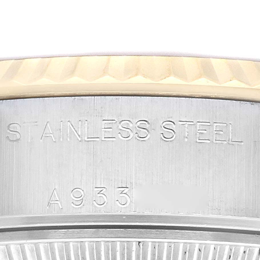 This close-up image shows the edge of the bezel and part of the caseback of a Rolex Datejust 79173 Women's Steel and Gold (two tone) Champagne Dial 79173 Women's Steel and Gold (two tone) Champagne Dial watch, highlighting the stainless steel lettering.