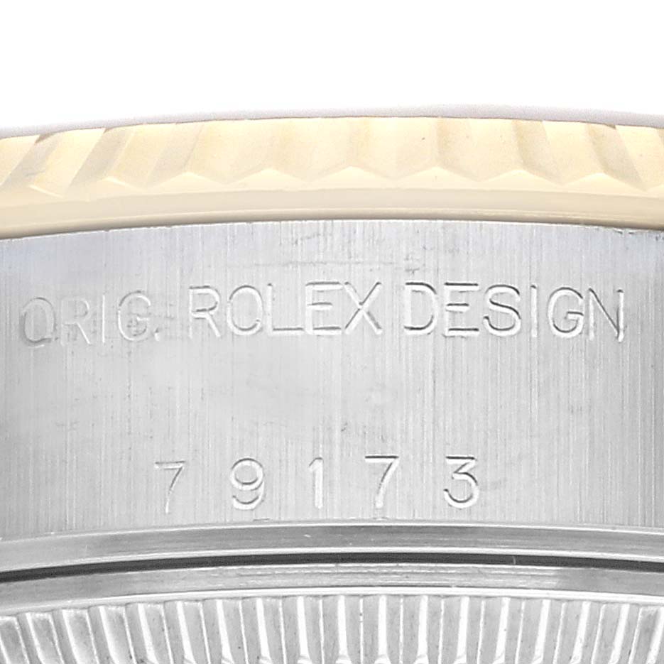 This image shows a close-up view of the engraving on the side case of a Rolex Datejust 79173 Women's Steel and Gold (two tone) Champagne Dial 79173 Women's Steel and Gold (two tone) Champagne Dial watch.