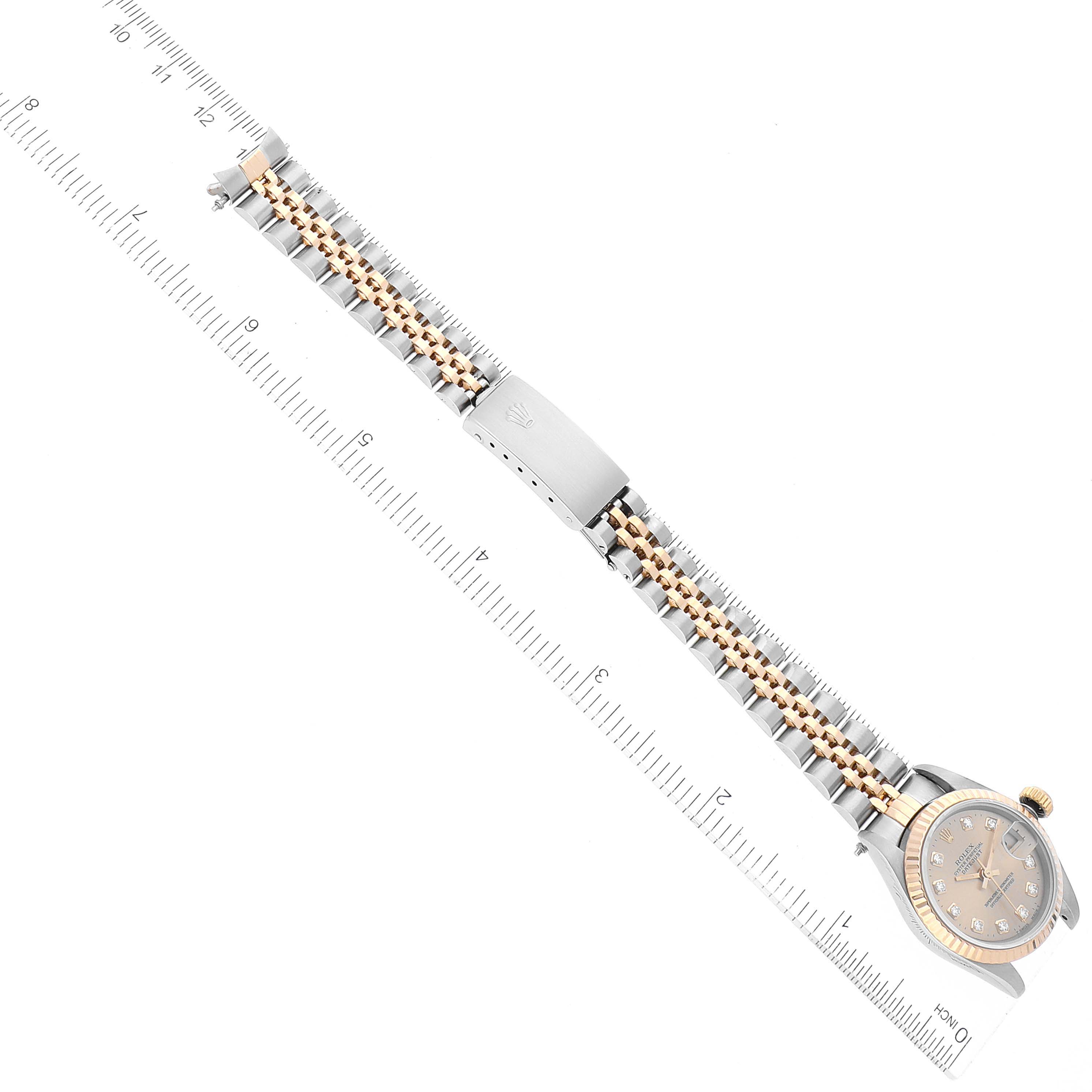 The image shows a Rolex Datejust 69173 Women's Steel and Gold (two tone) Champagne Dial 69173 Women's Steel and Gold (two tone) Champagne Dial watch laid flat, featuring its dial, bezel, bracelet, and clasp with the help of rulers.