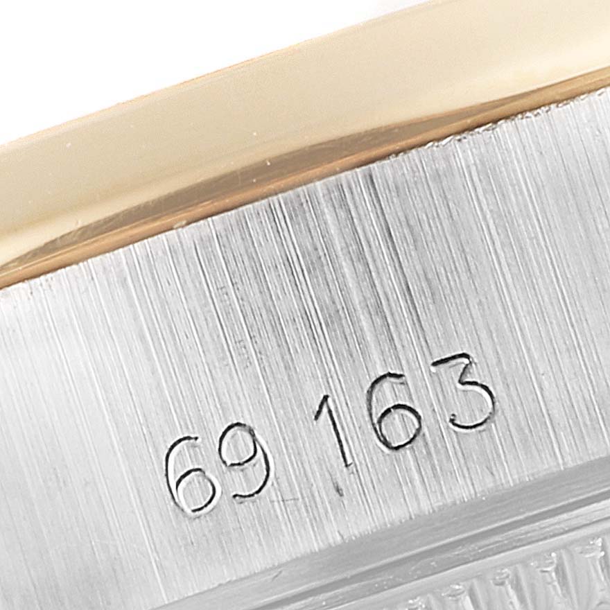 This image shows a close-up of the engraved serial number on the case rim of a Rolex Datejust 69163 Women's Steel and Gold (two tone) Grey Dial 69163 Women's Steel and Gold (two tone) Grey Dial watch.