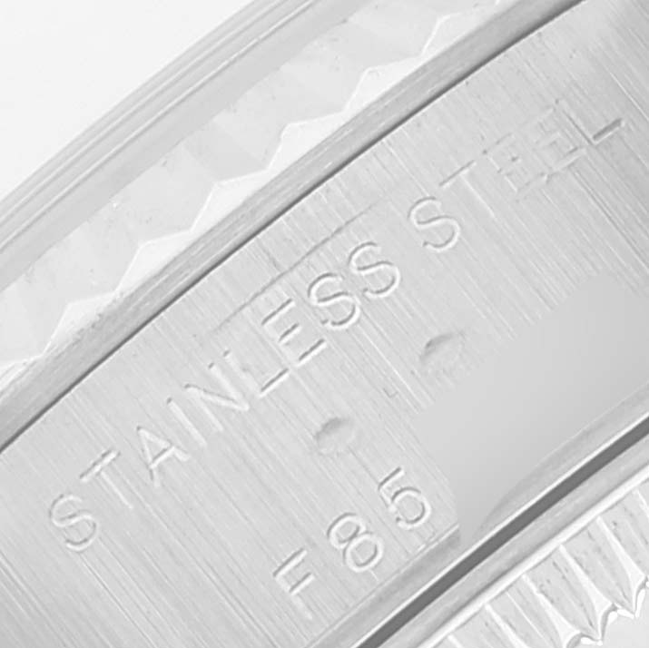 The image shows a close-up of the stainless steel caseback edge of a Rolex Datejust 79174 Women's Stainless Steel Mother of Pearl Dial 79174 Women's Stainless Steel Mother of Pearl Dial watch with engravings visible.