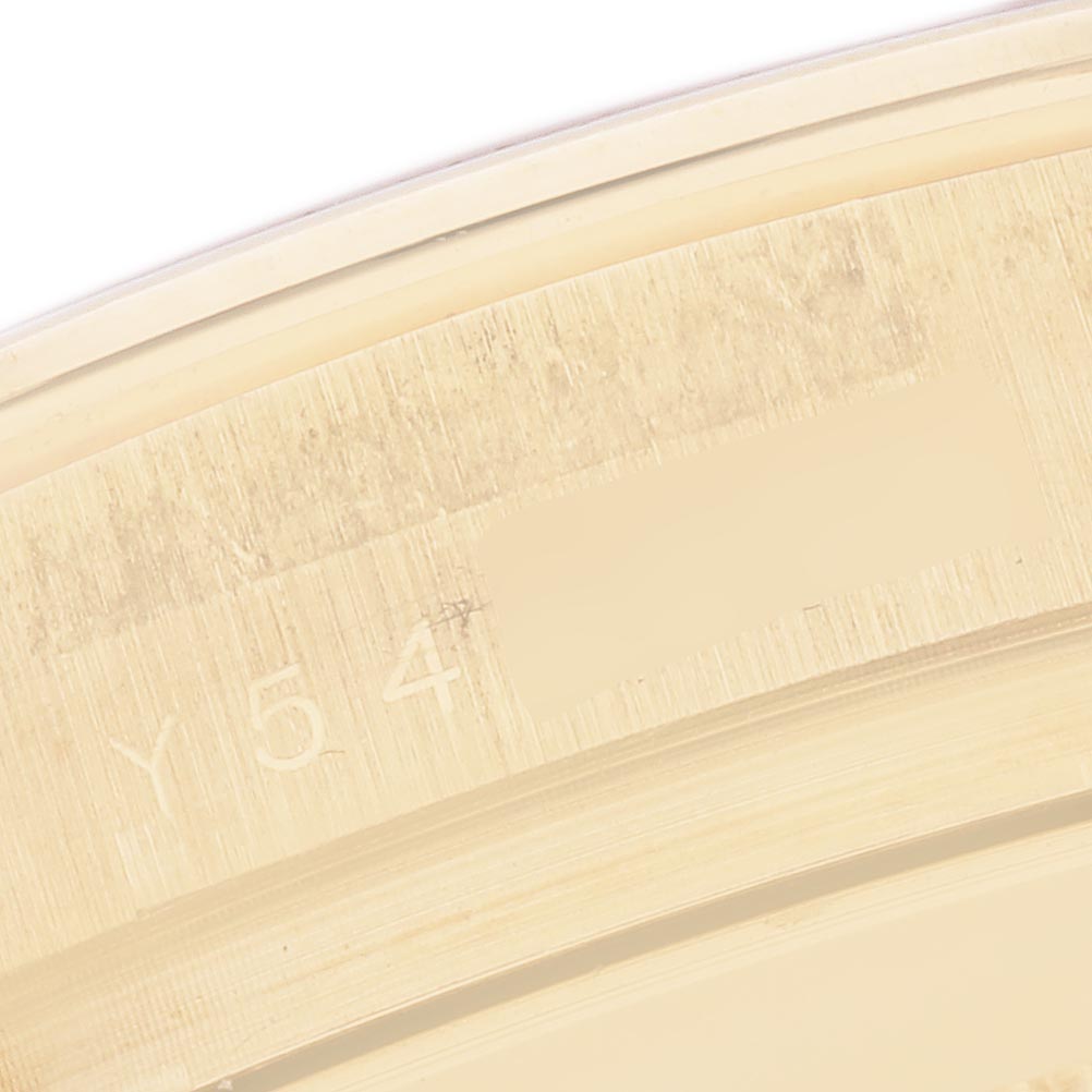 The image shows a close-up view of the edge or inner case of a Rolex Daytona 116528 Men's Yellow Gold Champagne Dial 116528 Men's Yellow Gold Champagne Dial, highlighting partial engraving details.