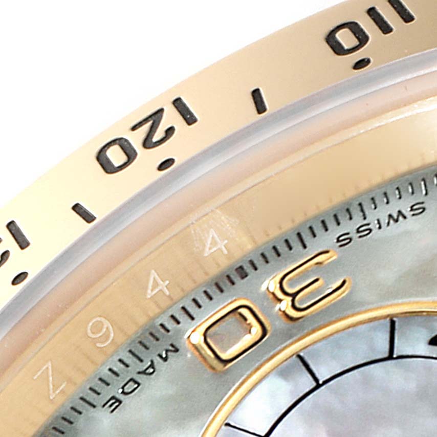 This close-up image of a Rolex Daytona 116528 Men
s Yellow Gold Mother of Pearl Dial 116528 Men
s Yellow Gold Mother of Pearl Dial watch shows the bezel and part of the chronograph dial.