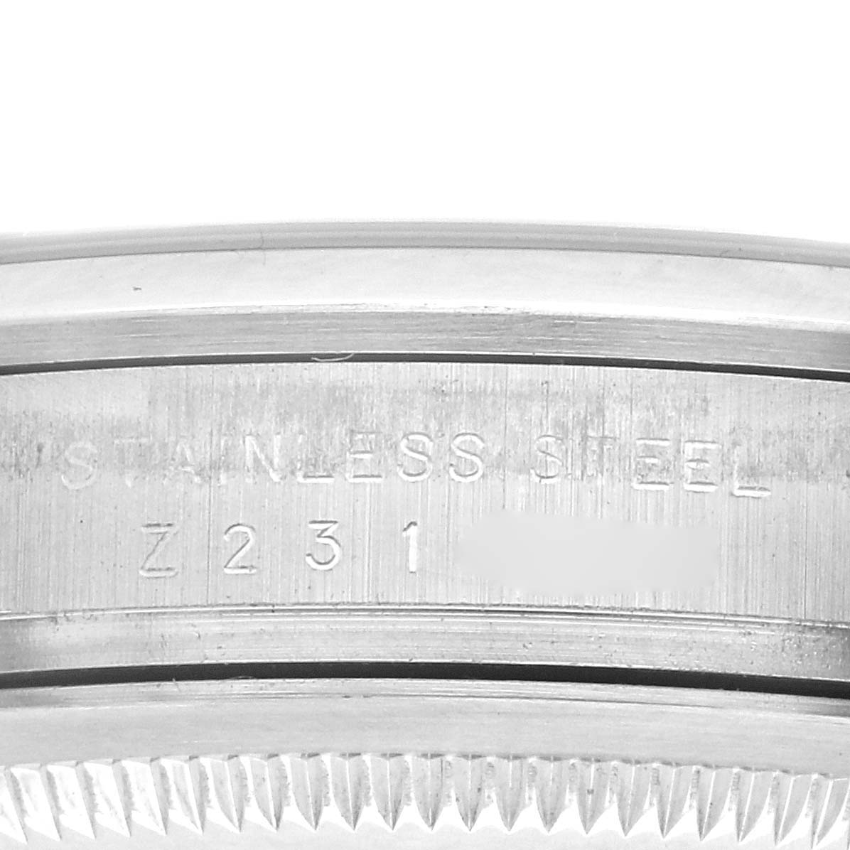 The image shows a close-up of the side of a Rolex Explorer 114270 Men's Stainless Steel Black Dial 114270 Men's Stainless Steel Black Dial watch, highlighting the stainless steel bezel with engraved details.