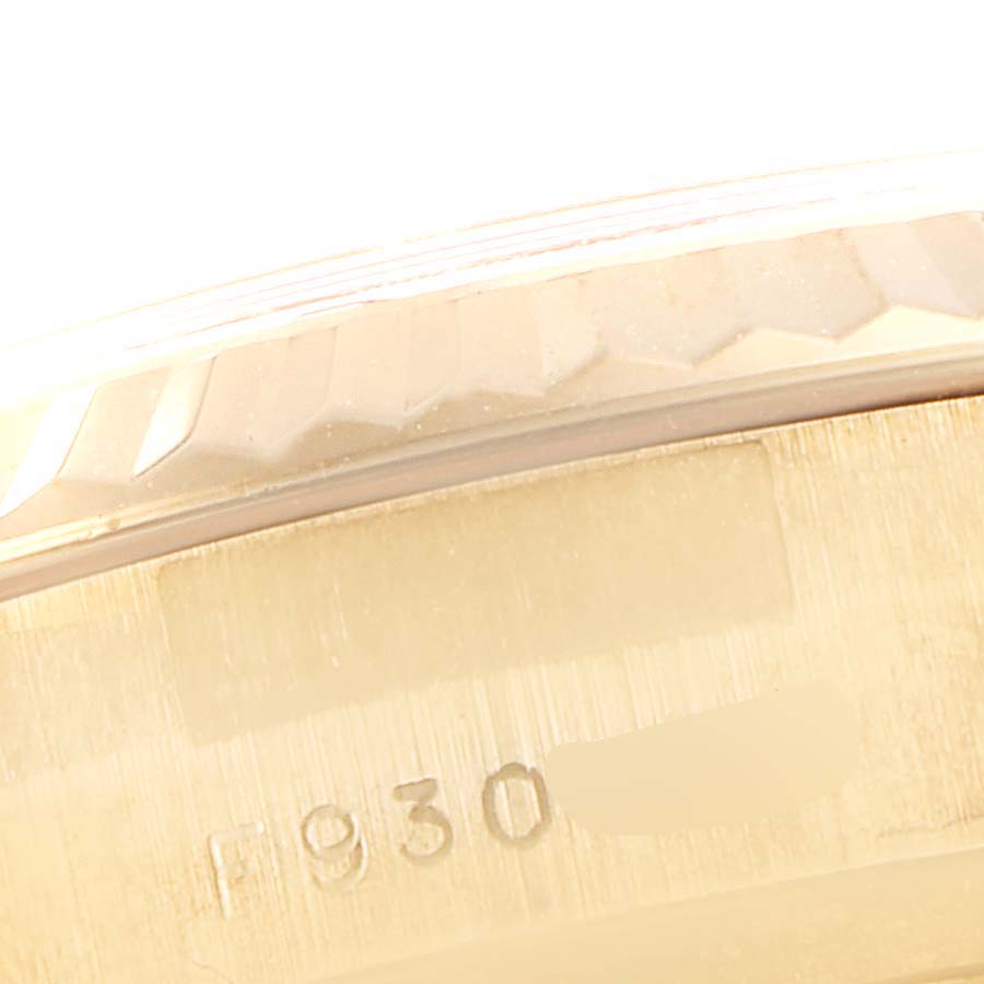 The image shows a close-up of the side of a Rolex President 179178 Women's Yellow Gold Mother of Pearl Dial 179178 Women's Yellow Gold Mother of Pearl Dial watch, focusing on the bezel and part of the case with some engraved numbers.
