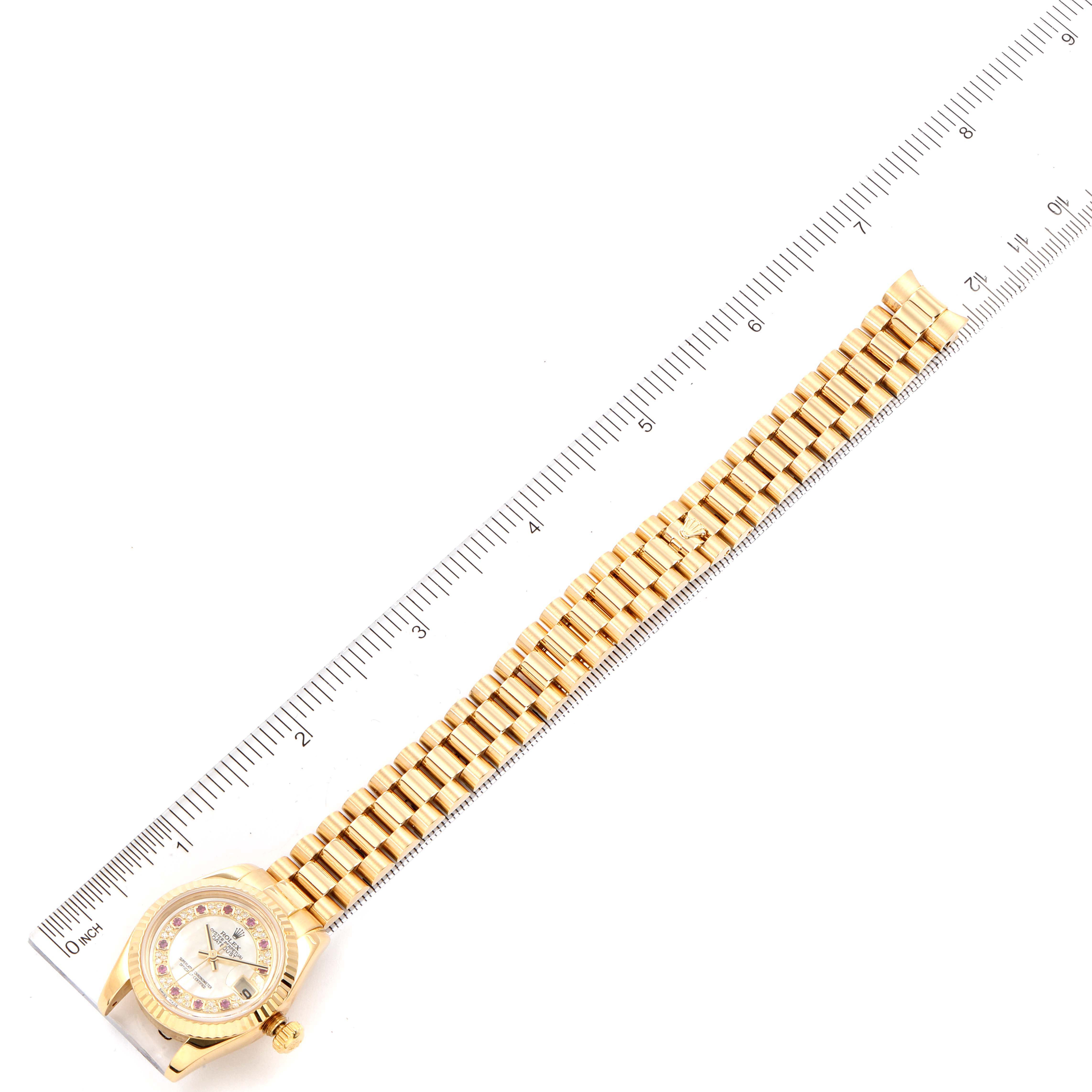 The image shows the face and bracelet of a Rolex President 179178 Women's Yellow Gold Mother of Pearl Dial 179178 Women's Yellow Gold Mother of Pearl Dial model watch, positioned adjacent to a ruler.