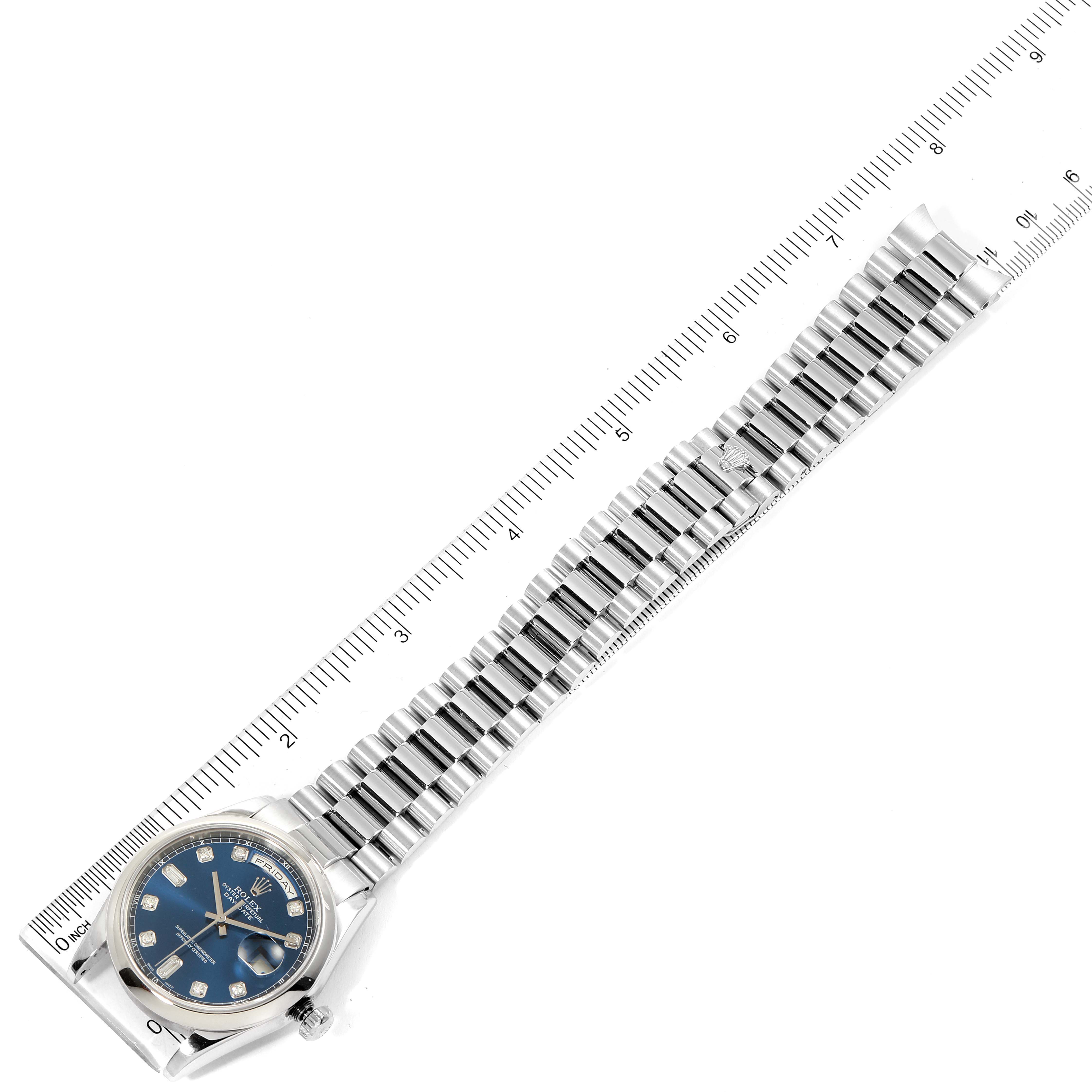 This image shows a Rolex President 118206 Men's White Gold Blue Dial 118206 Men's White Gold Blue Dial model watch with a blue dial and a full view of its bracelet, angled alongside a ruler for measurement.