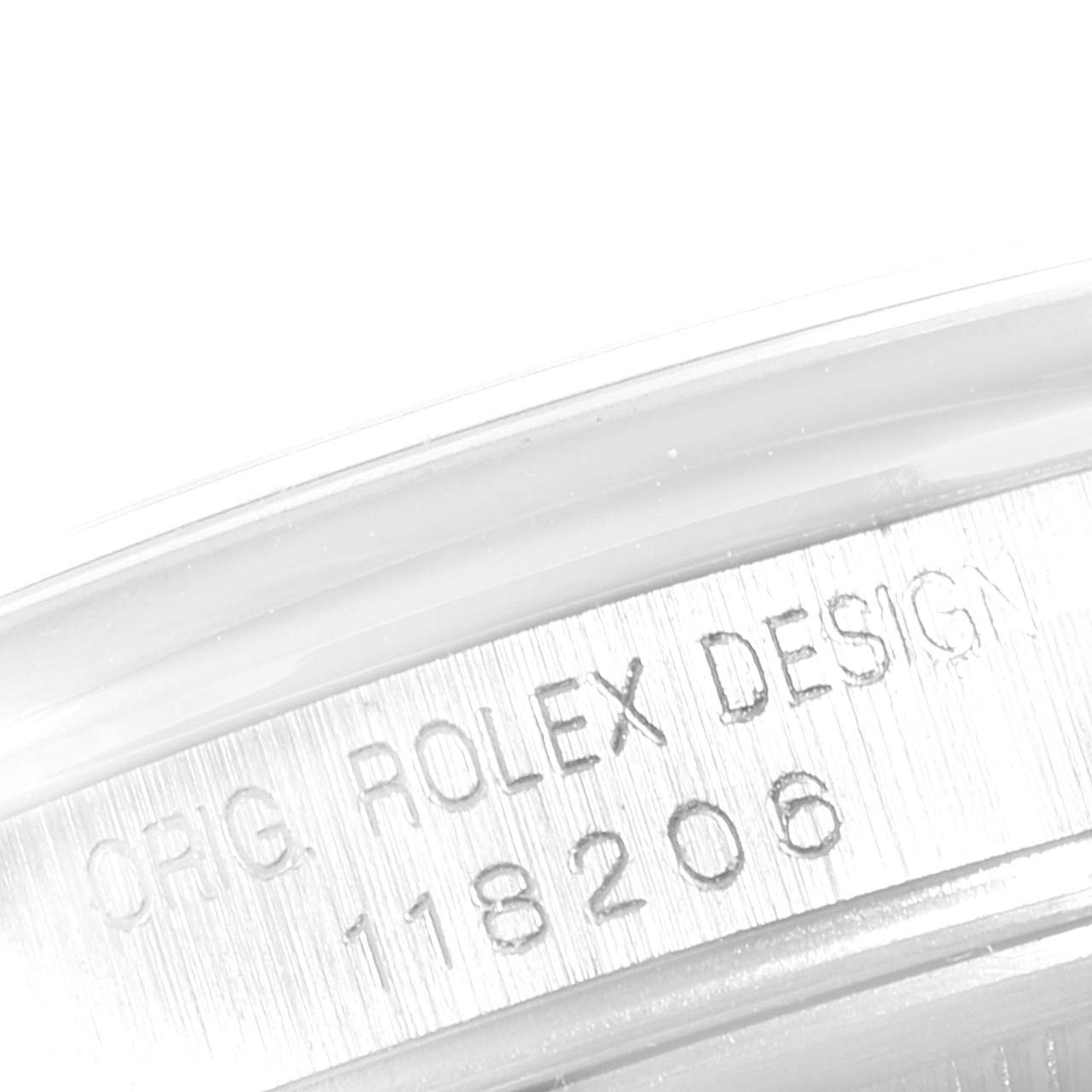 The image shows a close-up of the Rolex President 118206 Men's White Gold Blue Dial 118206 Men's White Gold Blue Dial model's case with the engraving "ORIG. ROLEX DESIGN 118206" visible.