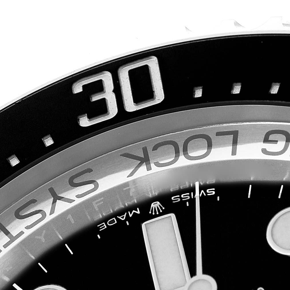 The image shows a close-up of the bezel and part of the dial of the Rolex Sea-Dweller M126660-0002 Men
s Stainless Steel Blue Dial M126660-0002 Men
s Stainless Steel Blue Dial model.