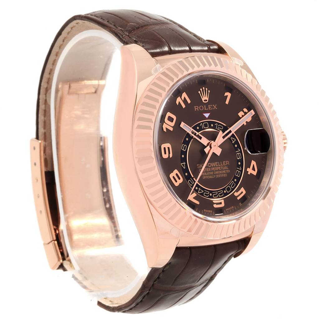 The image shows a side angle of a Rolex Sky-Dweller 326135 Men's Rose Gold Brown Dial 326135 Men's Rose Gold Brown Dial watch, highlighting its dial, bezel, and leather strap.