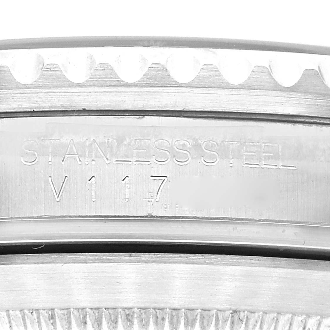 The image shows a close-up of the engraved stainless steel bezel edge of a Rolex Submariner 16610 Men
s Stainless Steel Black Dial 16610 Men
s Stainless Steel Black Dial watch.