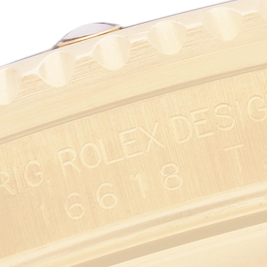 The image shows a close-up of the bezel and engraved side of a Rolex Submariner 16618 Men's Yellow Gold Black Dial 16618 Men's Yellow Gold Black Dial watch.