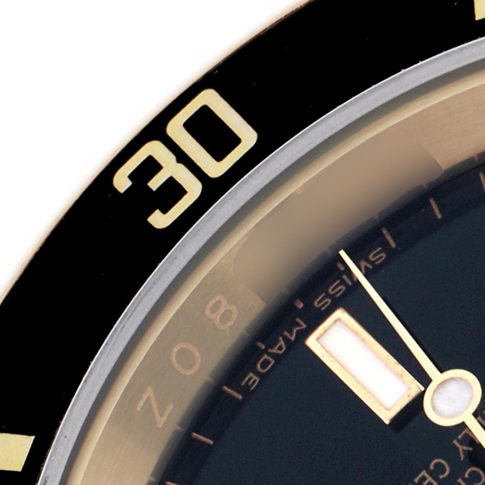 The image shows a close-up of the bezel and part of the dial of a Rolex Submariner 16618 Men's Yellow Gold Black Dial 16618 Men's Yellow Gold Black Dial watch.