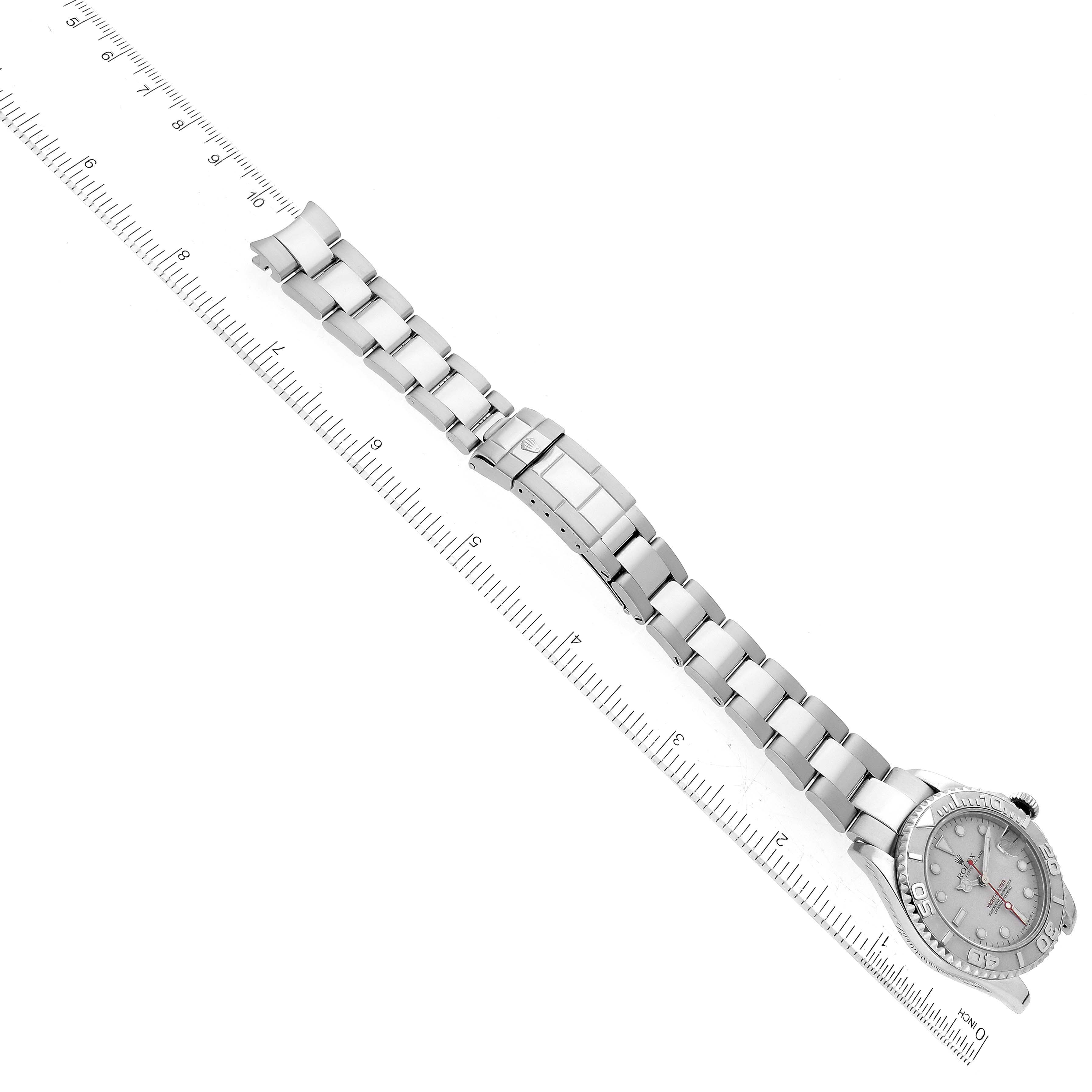 The image displays a side view of the Rolex Yacht-Master 168622 Men's Stainless Steel Silver Dial 168622 Men's Stainless Steel Silver Dial watch, highlighting its bracelet and clasp aligned with a ruler for scale.