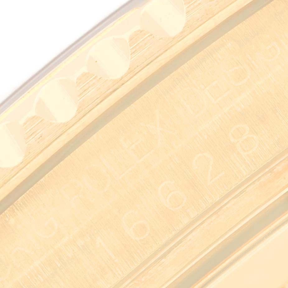 This image shows a close-up of the engraved inner bezel and part of the fluted bezel of the Rolex Yacht-Master 16628 Men's Yellow Gold White Dial 16628 Men's Yellow Gold White Dial watch.