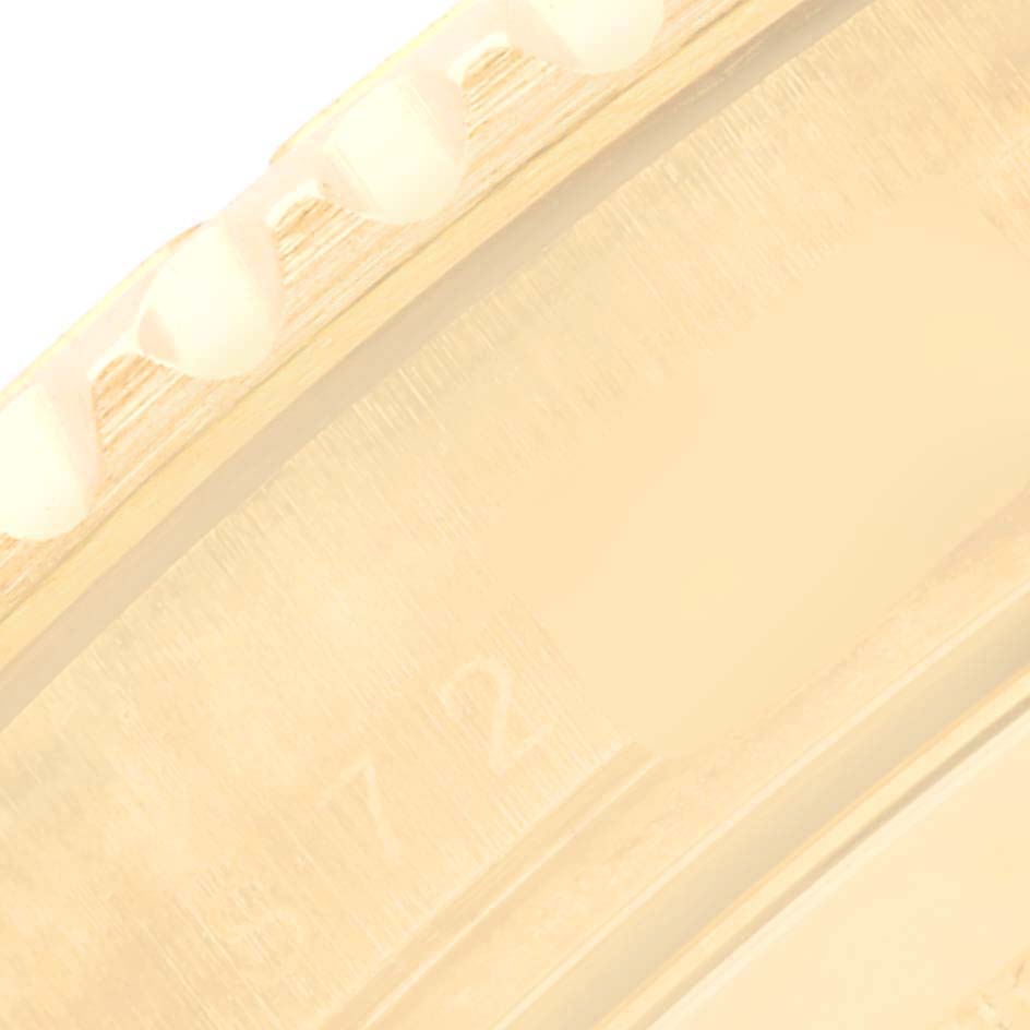 This is a close-up of the bezel edge and part of the case for the Rolex Yacht-Master 16628 Men's Yellow Gold White Dial 16628 Men's Yellow Gold White Dial watch.