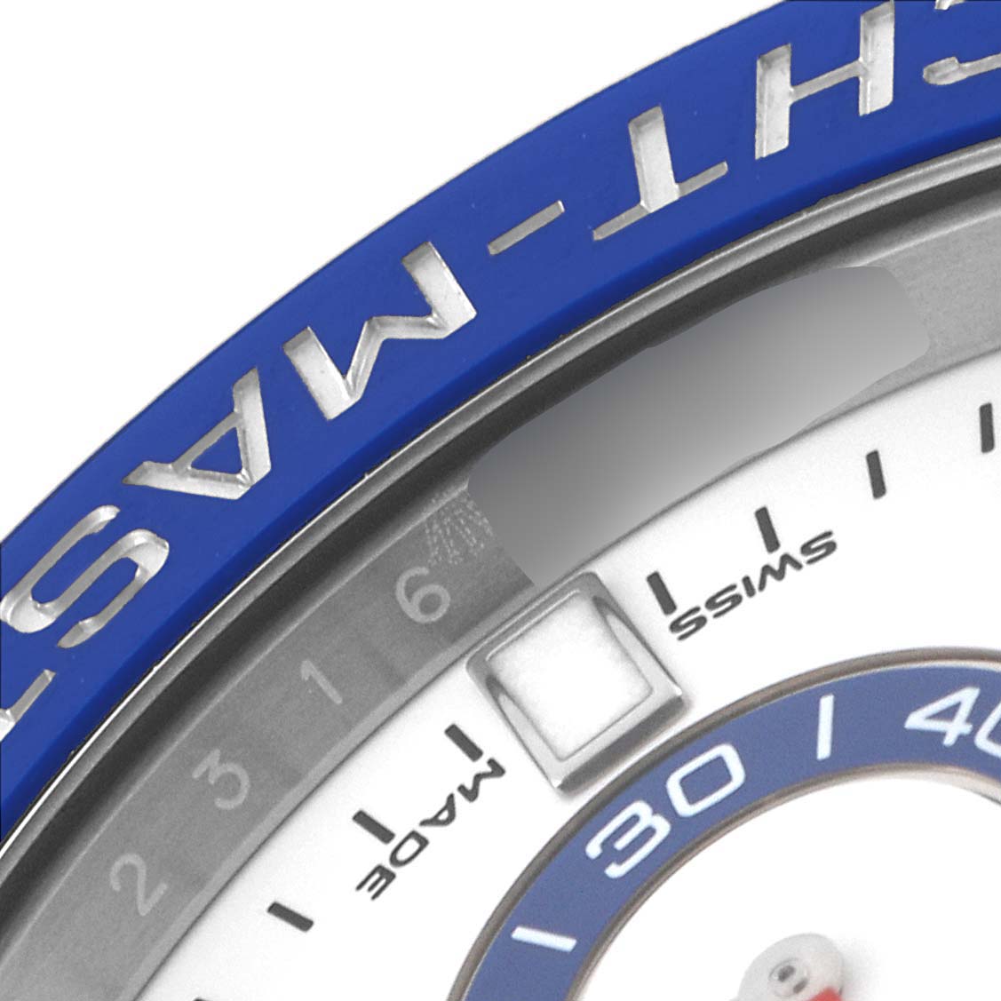 The image shows a close-up of the bezel and dial of a Rolex Yacht-Master 116680 Men's Stainless Steel White Dial 116680 Men's Stainless Steel White Dial watch, focusing on the "SWISS MADE" label and part of the blue bezel.